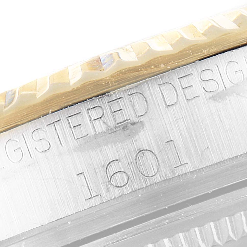 This close-up image shows the engraved model number "1601" on the bezel of a Rolex Vintage Collection 1601 Men's Steel and Gold (two tone) Silver Dial 1601 Men's Steel and Gold (two tone) Silver Dial watch.