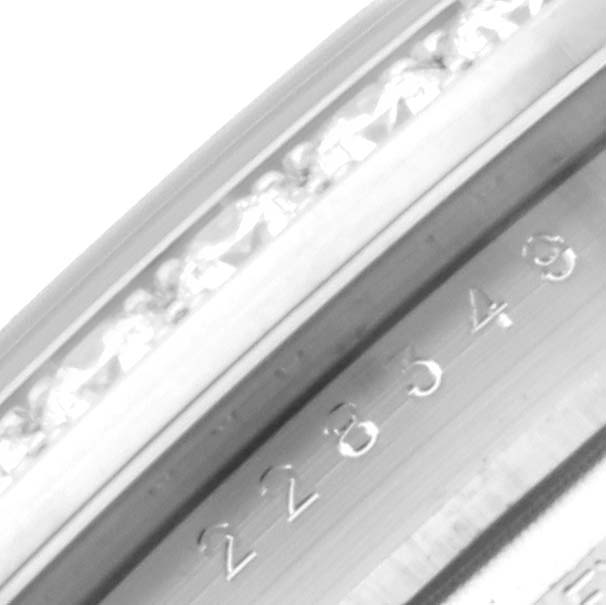 This close-up image shows part of the bezel and serial number of a Rolex President 228349 Men's White Gold Green Dial 228349 Men's White Gold Green Dial model watch.