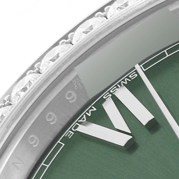 This image shows a close-up angle of the face and bezel of a Rolex President 228349 Men's White Gold Green Dial 228349 Men's White Gold Green Dial model watch with visible Roman numeral markers.