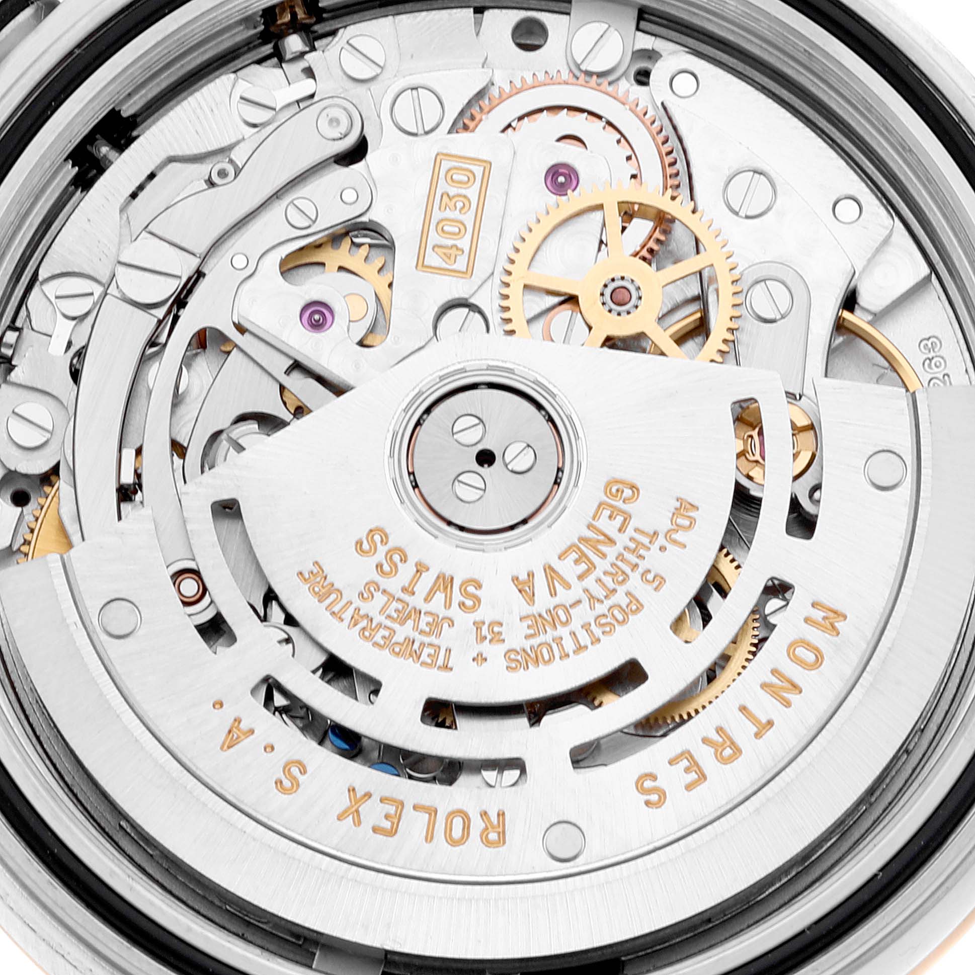 The image shows the detailed internal movement and mechanisms of a Rolex Daytona 16523 Men
s Steel and Gold (two tone) White Dial 16523 Men
s Steel and Gold (two tone) White Dial watch, focusing on gears and engravings.