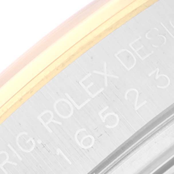 This image shows a close-up of the engraved text on the side of the bezel of a Rolex Daytona 16523 Men
s Steel and Gold (two tone) White Dial 16523 Men
s Steel and Gold (two tone) White Dial watch.