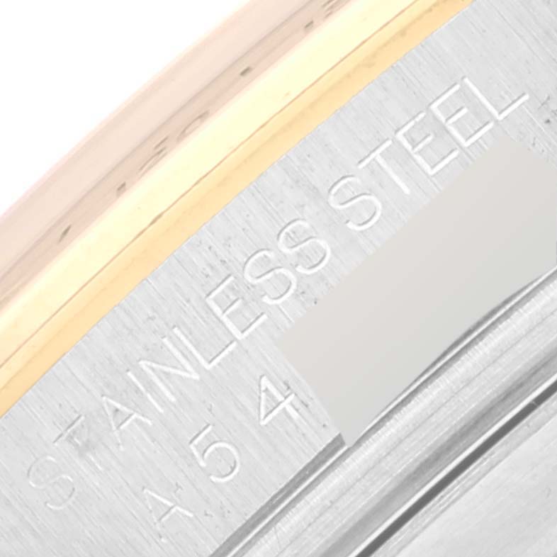 This image shows a close-up of the edge of a Rolex Daytona 16523 Men
s Steel and Gold (two tone) White Dial 16523 Men
s Steel and Gold (two tone) White Dial wristwatch, highlighting the stainless steel material.