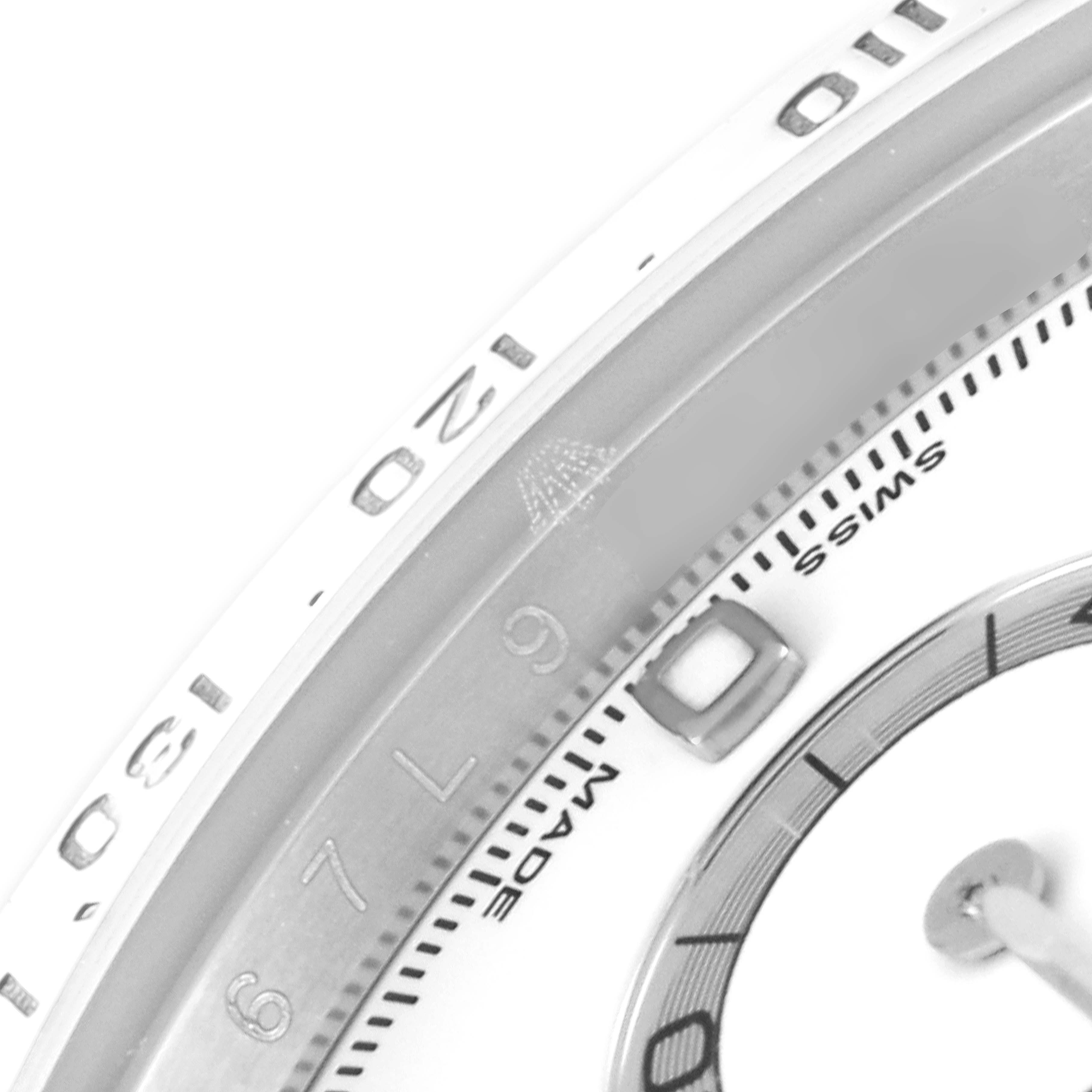 The image shows a close-up of the dial and outer bezel of a Rolex Daytona 116520 Men
s Stainless Steel White Dial 116520 Men
s Stainless Steel White Dial watch, focusing on the numerals and inscriptions.