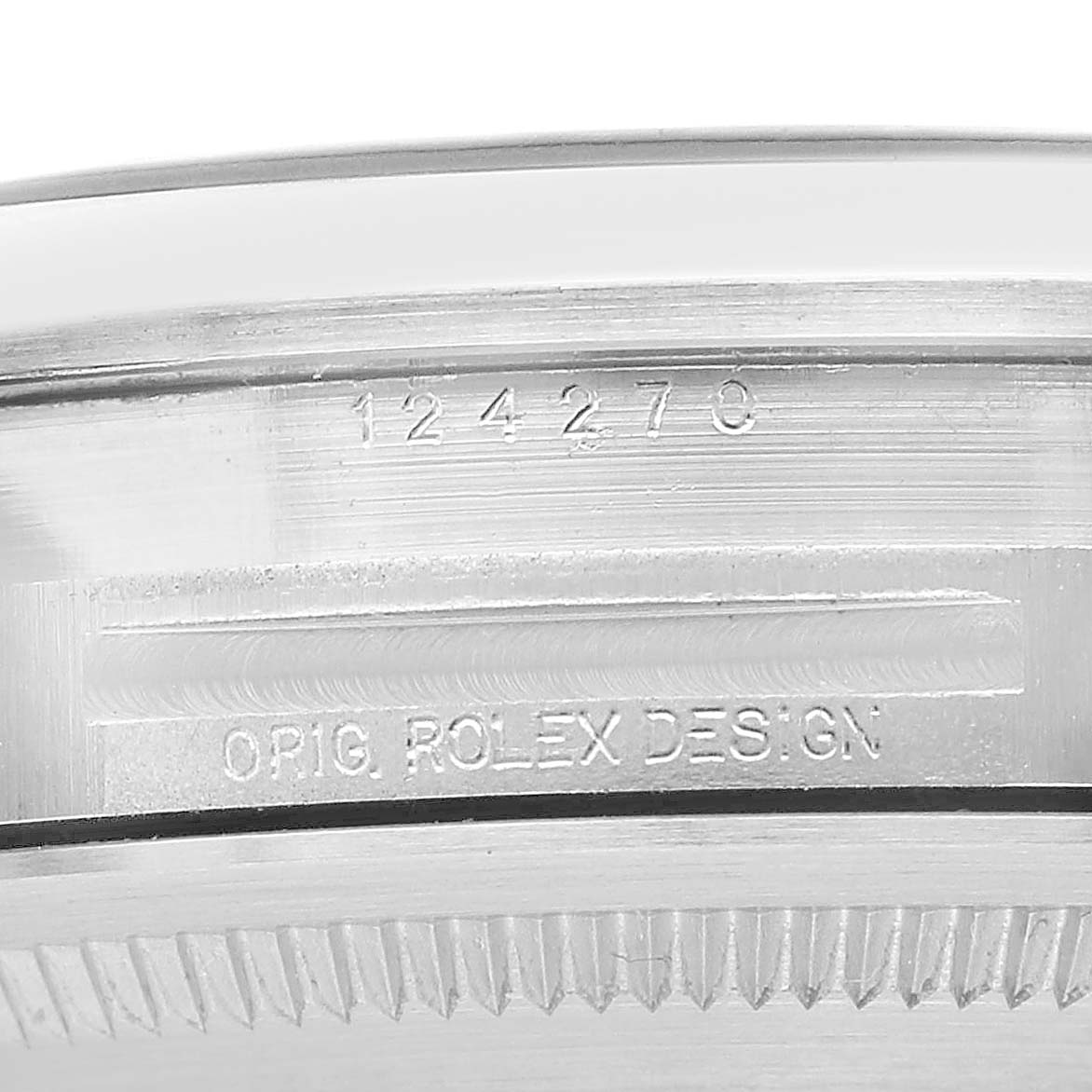 The image shows a close-up of the side of the Rolex Explorer 124270 Men's Stainless Steel Black Dial model case, displaying the model number and "ROLEX DESIGN" engraving.