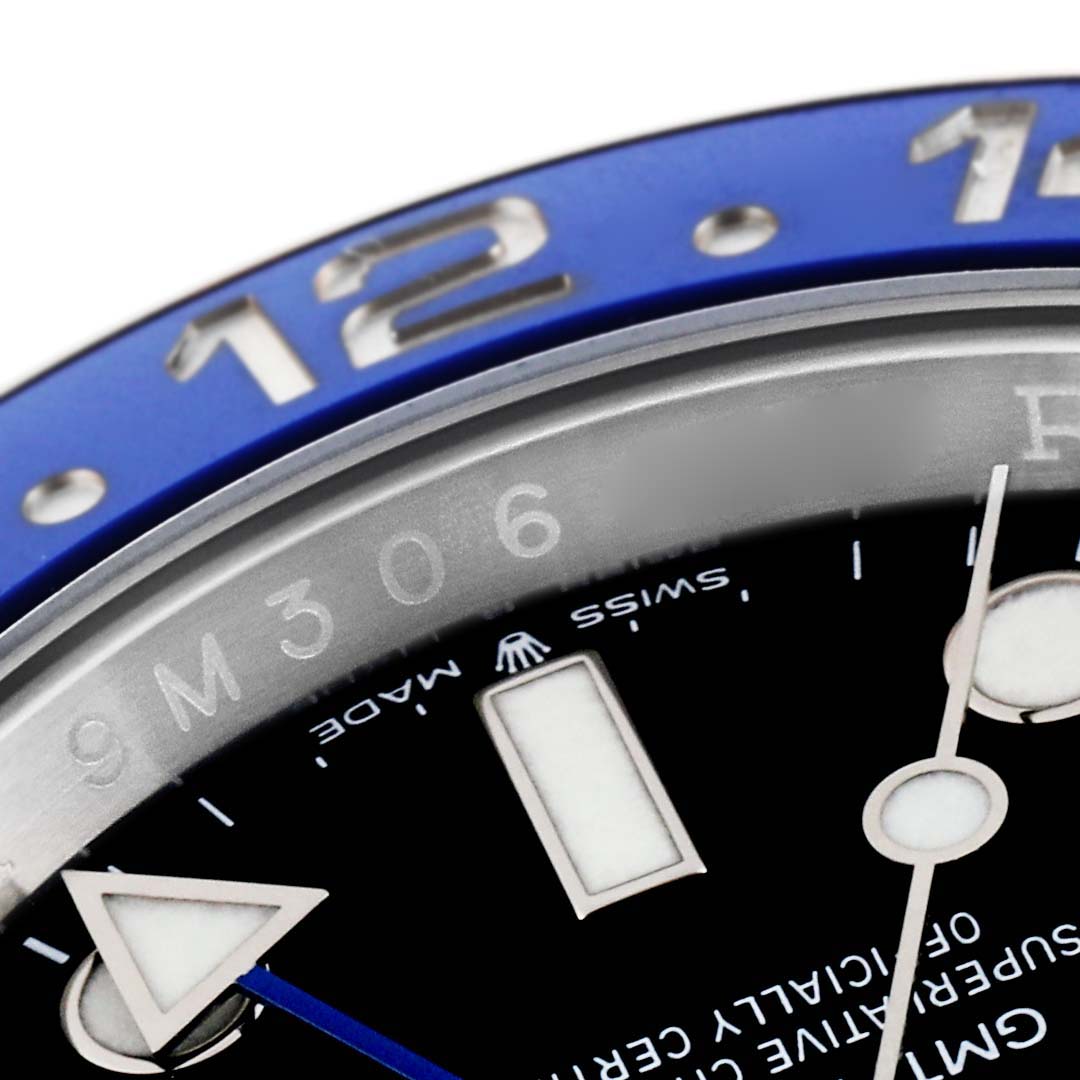 This close-up image of a Rolex GMT-Master 126710 Men's Stainless Steel Black Dial 126710 Men's Stainless Steel Black Dial watch showcases the bezel, partial dial, and hour markers, including the 12 o'clock marker.