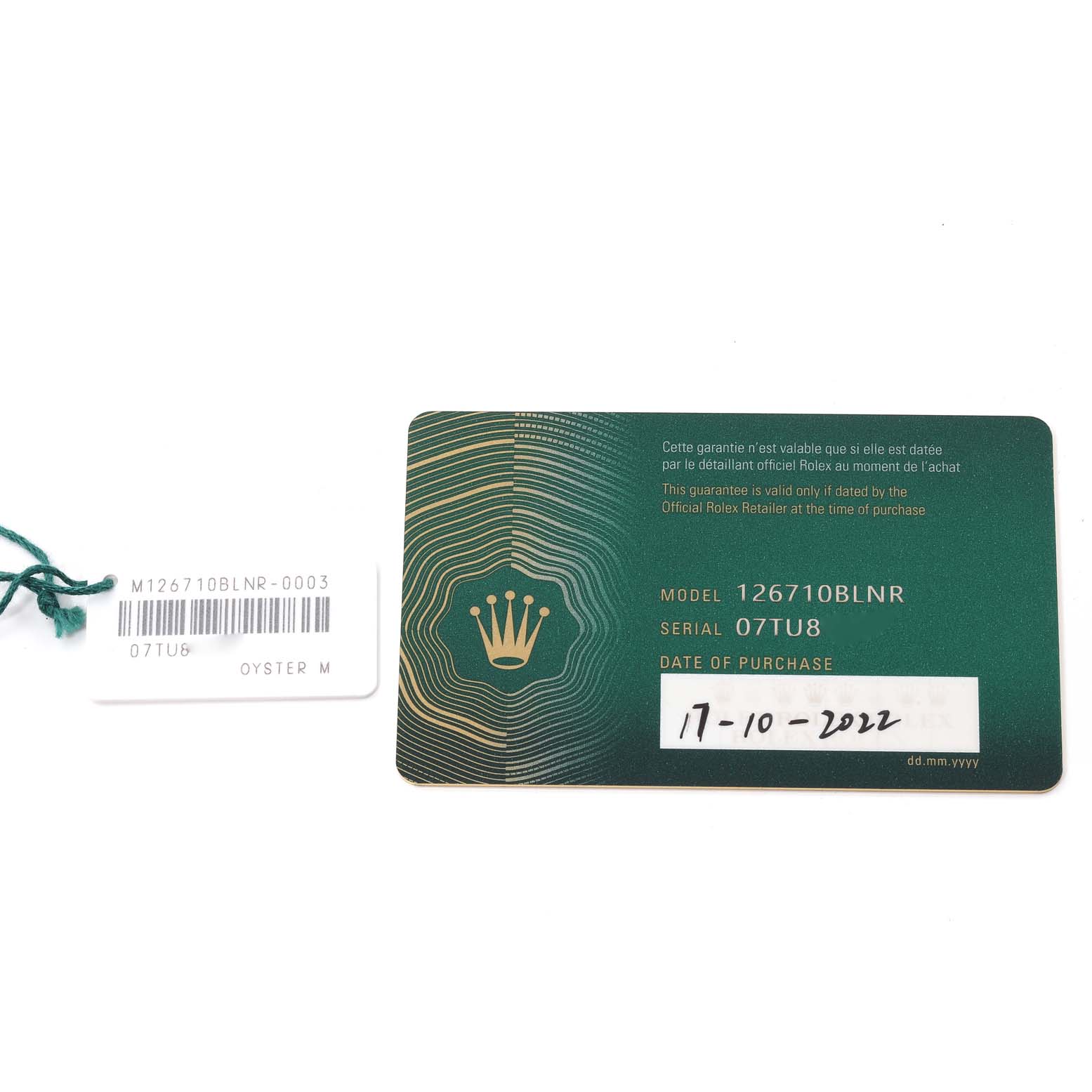 The image shows the warranty card and a tag for a Rolex GMT-Master 126710 Men's Stainless Steel Black Dial 126710 Men's Stainless Steel Black Dial model 126710BLNR with the serial number 07TU8.