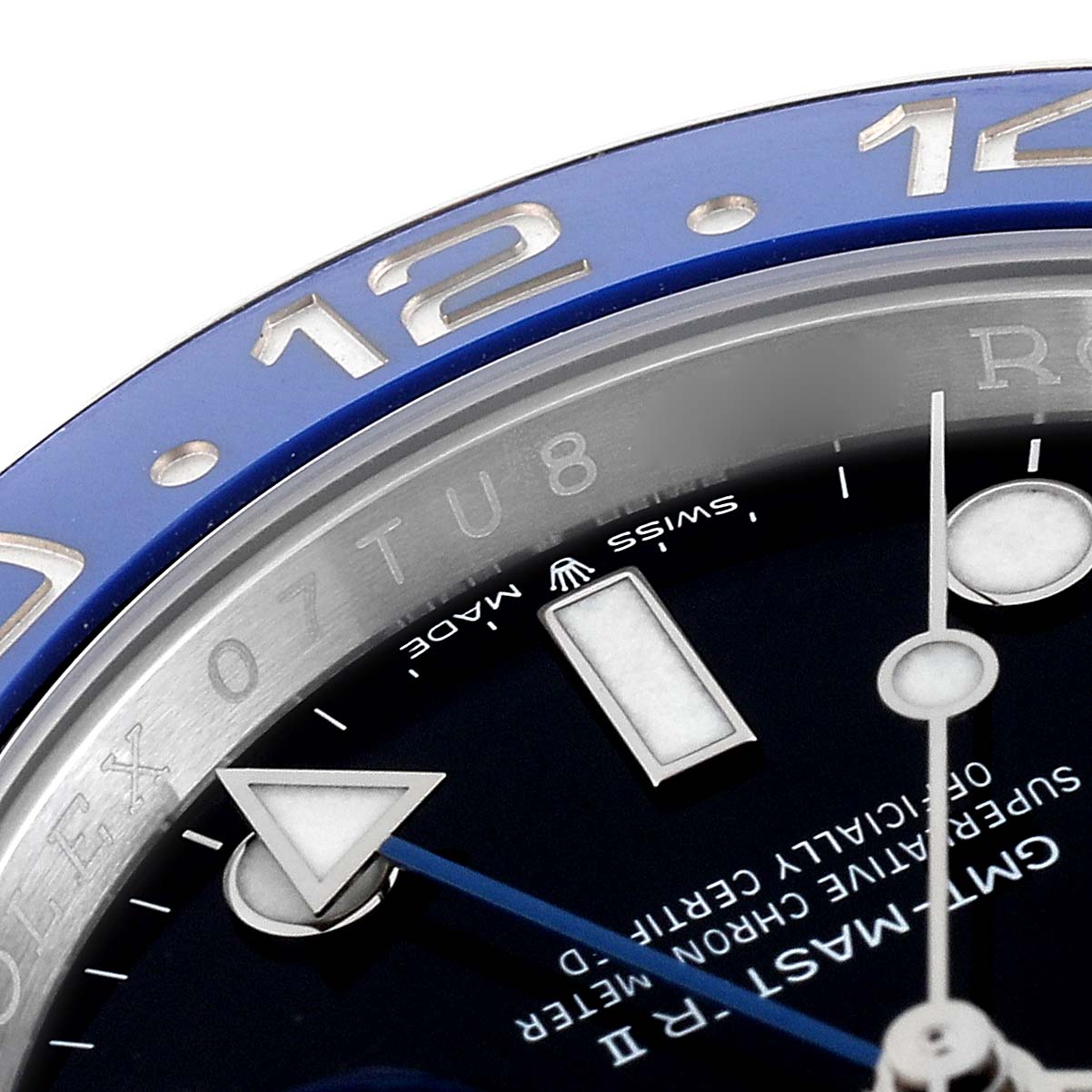 The image shows a close-up of the bezel and dial of a Rolex GMT-Master 126710 Men's Stainless Steel Black Dial 126710 Men's Stainless Steel Black Dial watch, highlighting the "12" marker and part of the hands.