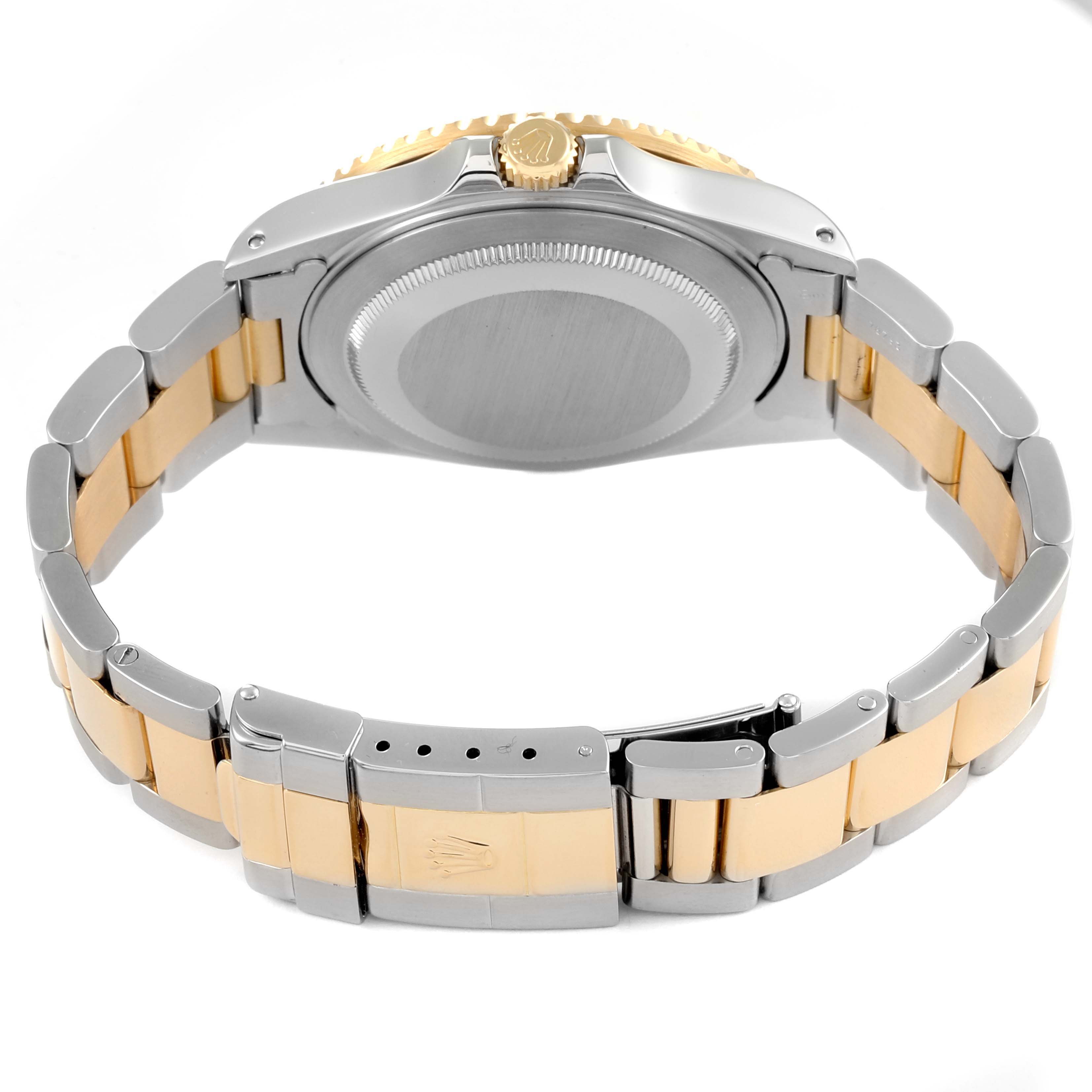 The image shows a rear view of a Rolex GMT-Master 16713 Men's Steel and Gold (two tone) Champagne Dial 16713 Men's Steel and Gold (two tone) Champagne Dial watch, highlighting the two-tone bracelet, clasp, and case back.