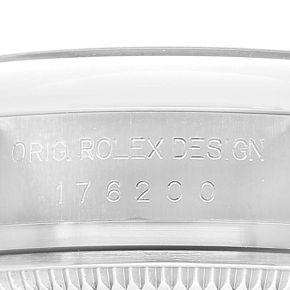 The image shows a close-up of the case side of a Rolex Oyster Perpetual 176200 Women's Stainless Steel Black Dial watch, highlighting the engraved model and design details.