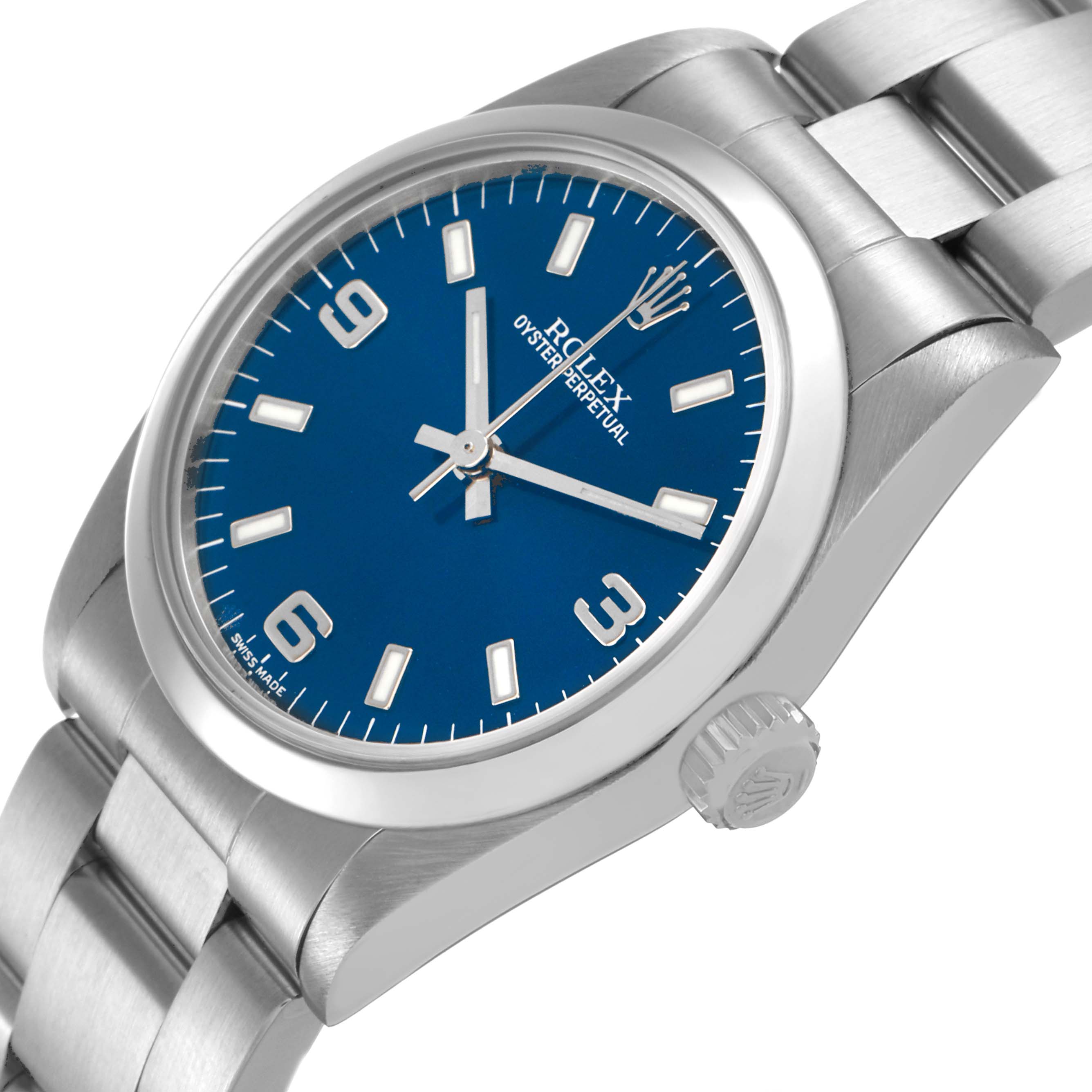The Rolex Mid-Size 77080 Women's Stainless Steel Blue Dial watch is shown at a three-quarter angle, highlighting the blue dial, bezel, and part of the bracelet.