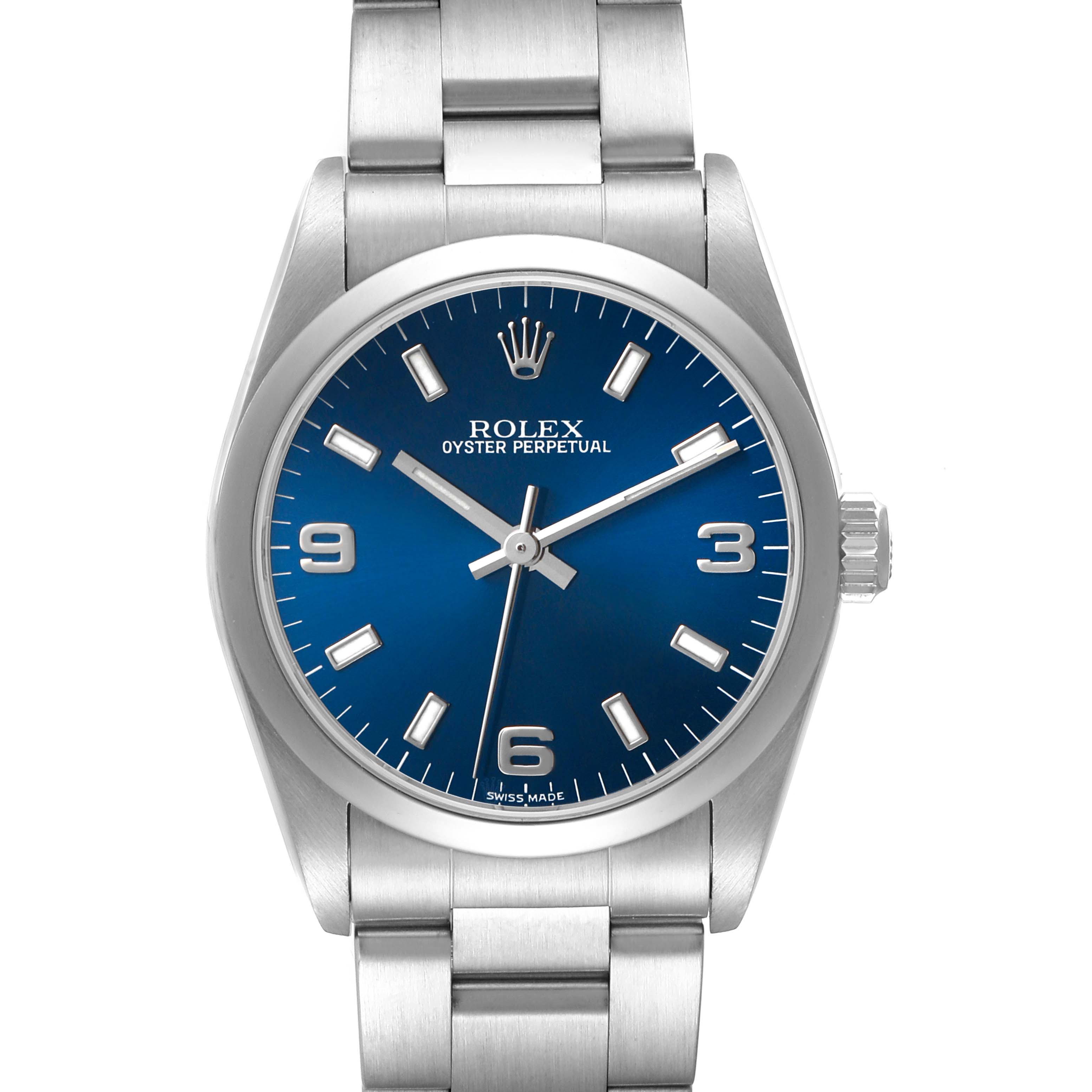 The Rolex Oyster Perpetual Mid-Size watch is shown from the front, displaying the blue dial, hour markers, case, crown, and bracelet.