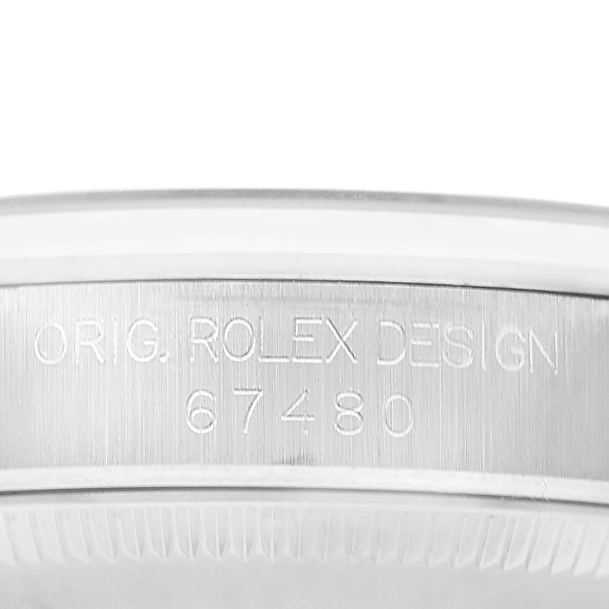 The image shows the side engraving on the case of the Rolex Mid-Size 67480 Women's Stainless Steel Black Dial watch, displaying "Orig. Rolex Design" and a model number.