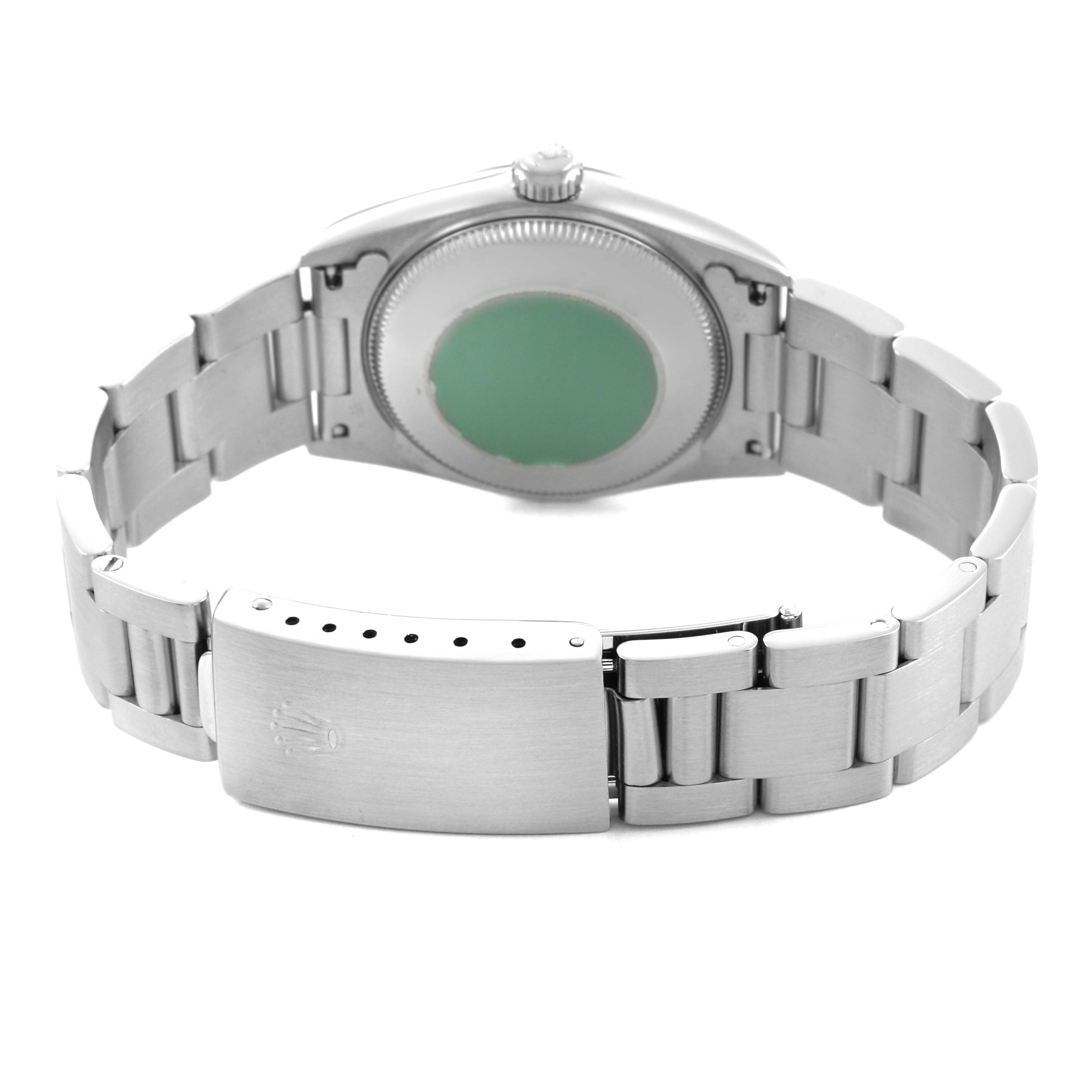 The image shows the back view of a Rolex Mid-Size 67480 Women's Stainless Steel Black Dial watch, featuring the case back, bracelet, and clasp.