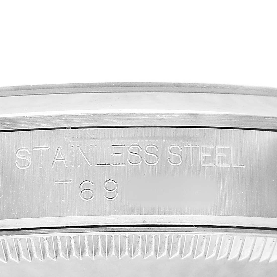 The image shows the side of a Rolex Mid-Size 67480 Women's Stainless Steel Black Dial watch casing with "STAINLESS STEEL" engraved on it.