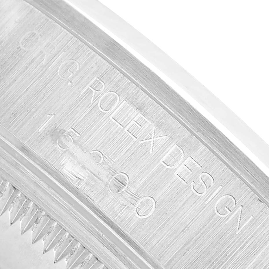 The image shows an angled close-up of the side of a Rolex Date 15200 Men's Stainless Steel White Dial model watch, highlighting the engraved details on the case.