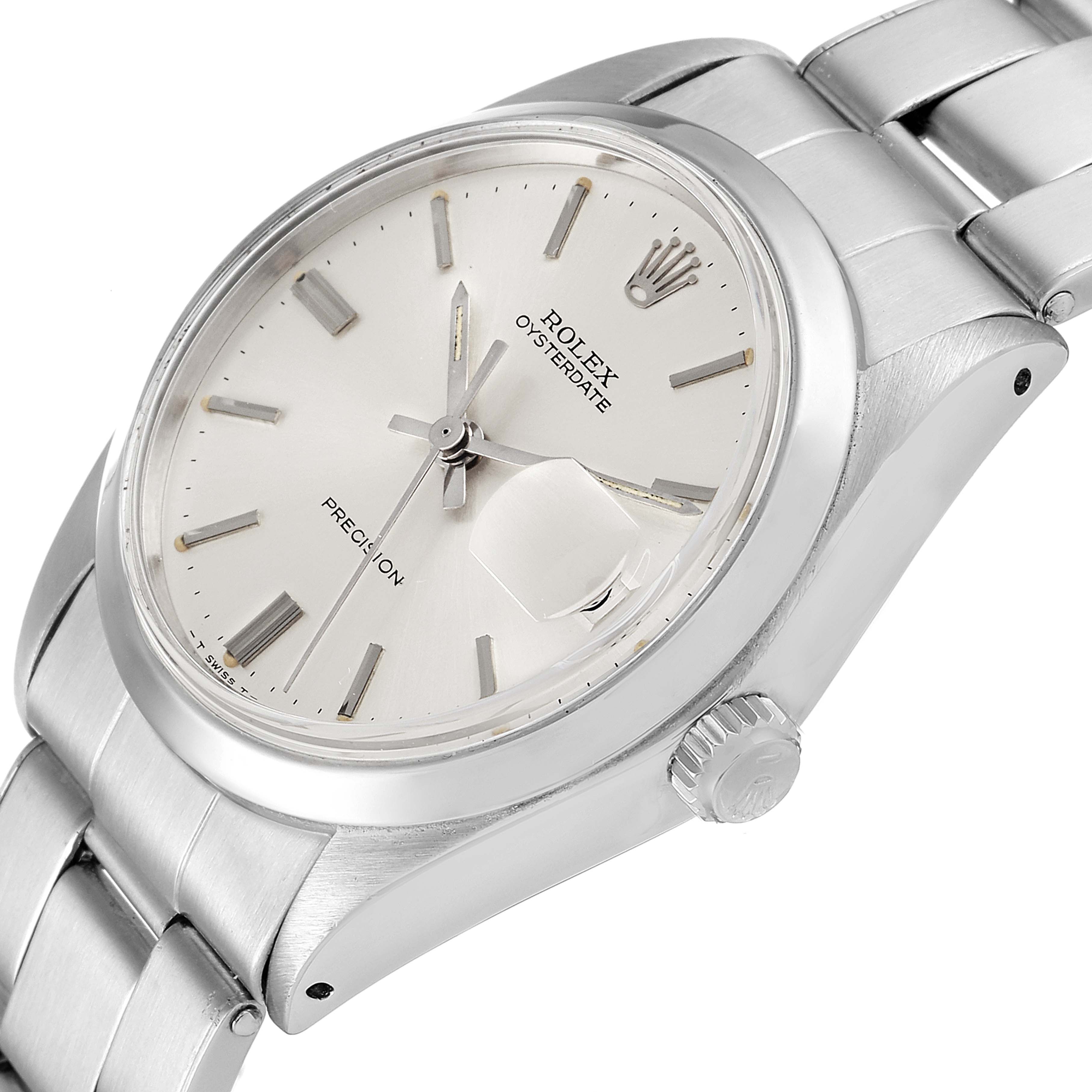 The image shows a Rolex Vintage Collection 6694 Men
s Stainless Steel Silver Dial 6694 Men
s Stainless Steel Silver Dial Oysterdate watch from an angled top view, highlighting the dial, bezel, crown, and bracelet.