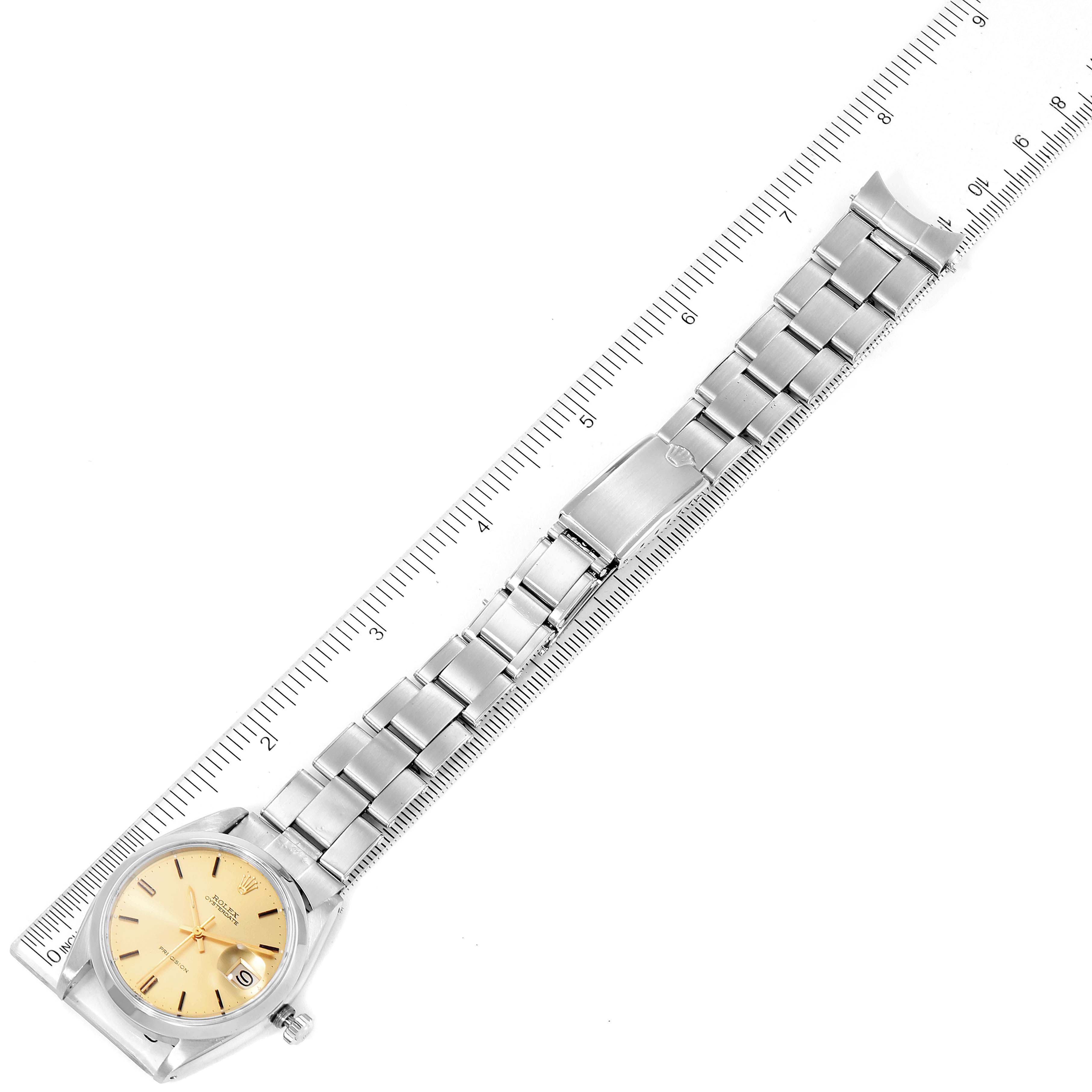 The image shows the Rolex Vintage Collection 6694 Men's Stainless Steel Champagne Dial 6694 Men's Stainless Steel Champagne Dial model watch from a top-down angle, including the entire band and face, with a ruler for scale.
