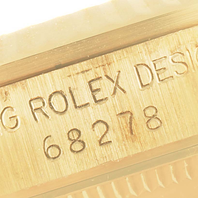 The image shows a close-up of the engraved case side of a Rolex President 68278 Women
s Yellow Gold Champagne Dial 68278 Women
s Yellow Gold Champagne Dial 68278 watch, highlighting its model number and branding.