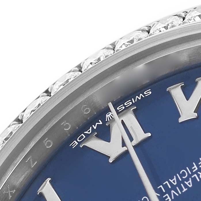 The image shows a close-up of the Rolex President 278289 Women's White Gold Blue Dial model's blue dial, bezel with diamonds, and Roman numerals at an oblique angle.