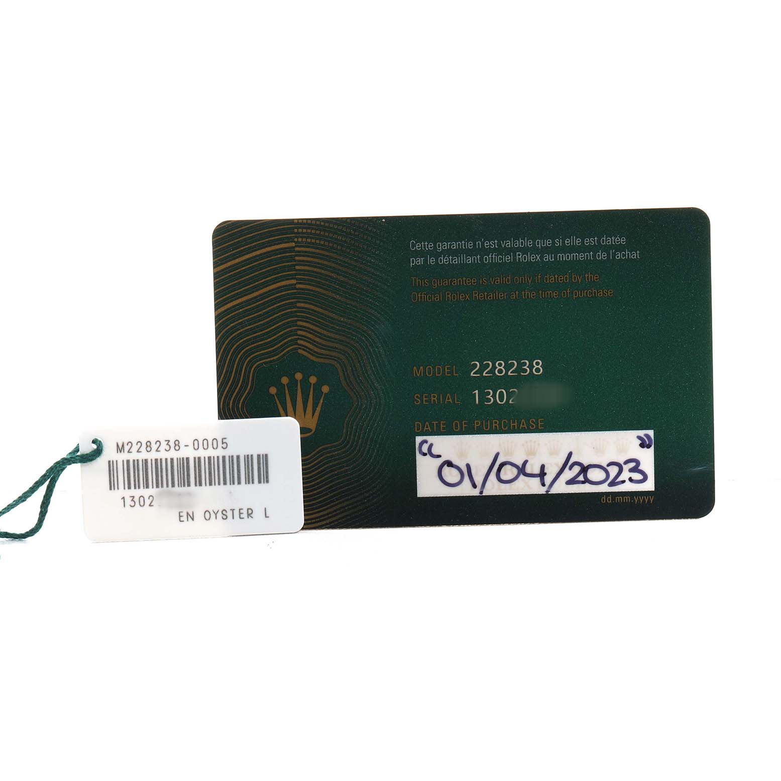 The image shows a Rolex President 228238 Men's Yellow Gold Champagne Dial model warranty card and a tag with model and serial numbers.