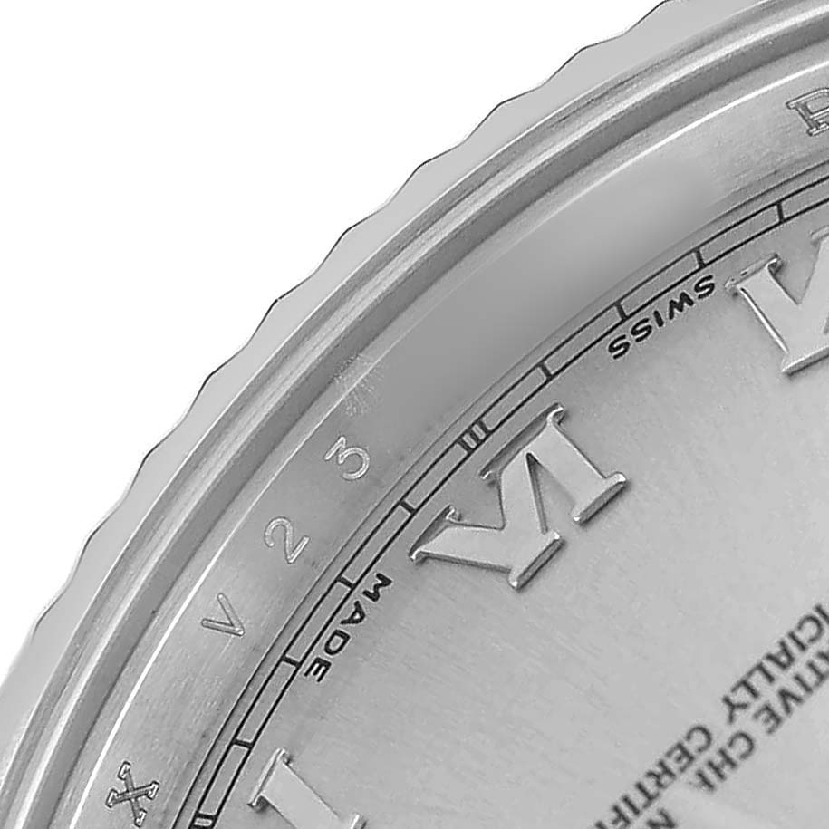 The image shows a close-up of the bezel and part of the dial of a Rolex President 218239 Men's White Gold Silver Dial watch, emphasizing Roman numerals and details.