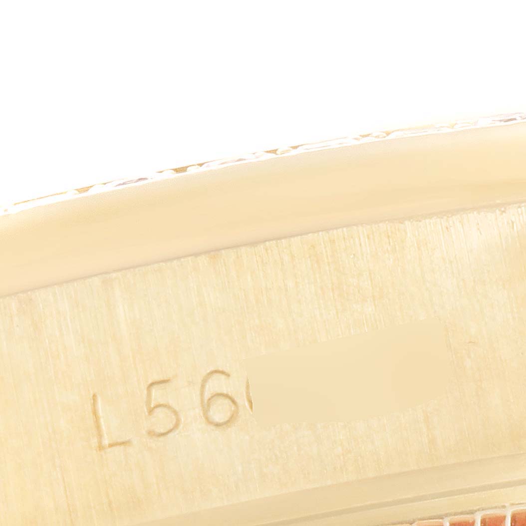 This image shows a close-up view of the case with visible engraving on a Rolex President 69138 Women's Yellow Gold Blue Dial 69138 Women's Yellow Gold Blue Dial model watch.