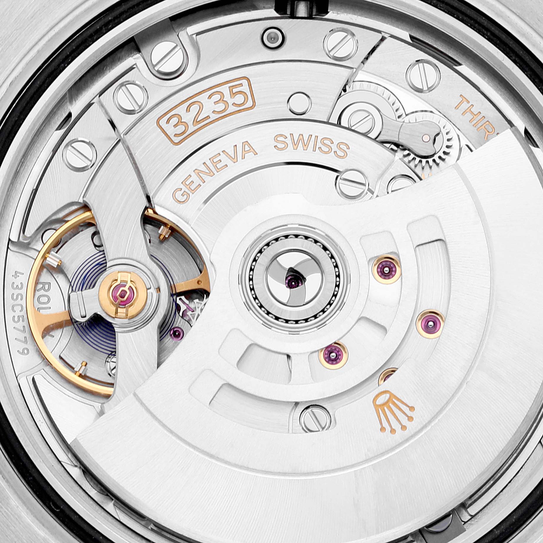 This image shows a close-up view of the movement inside a Rolex Submariner 126613 Men's Steel and Gold (two tone) Black Dial 126613 Men's Steel and Gold (two tone) Black Dial watch, highlighting intricate components and engravings.