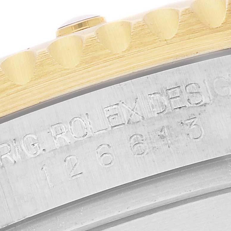 The image shows a close-up of the model number and bezel teeth of a Rolex Submariner 126613 Men's Steel and Gold (two tone) Blue Dial 126613 Men's Steel and Gold (two tone) Blue Dial watch.