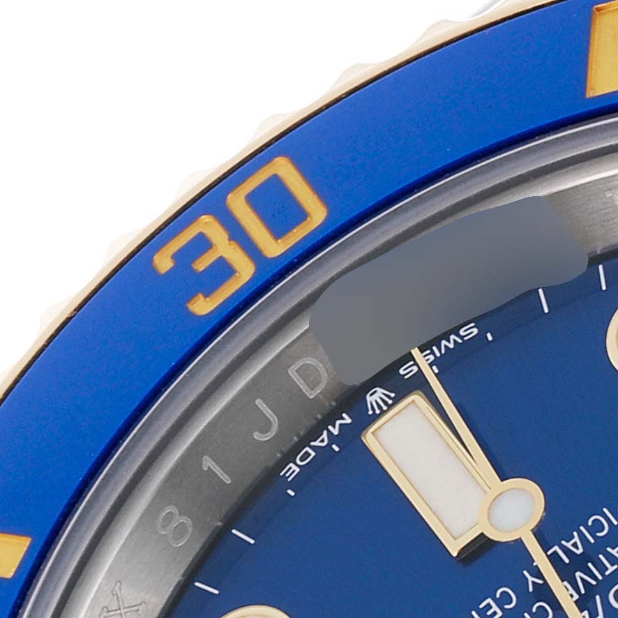 This image shows a close-up of the dial, bezel, and minute hand of the Rolex Submariner 126613 Men's Steel and Gold (two tone) Blue Dial 126613 Men's Steel and Gold (two tone) Blue Dial watch.