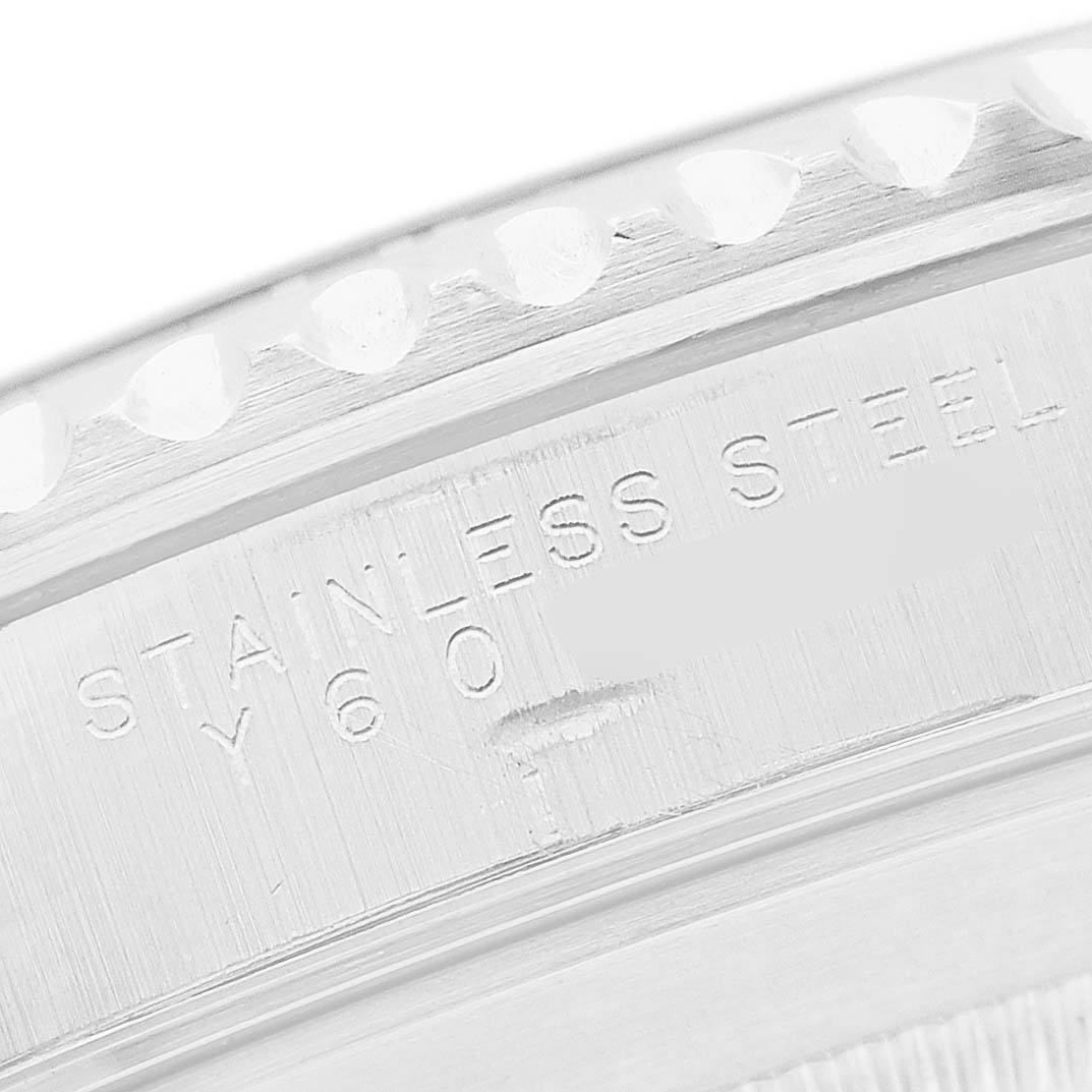 The image shows a close-up of the inner bezel and engraved text on a Rolex Submariner 14060 Men's Stainless Steel Black Dial watch.