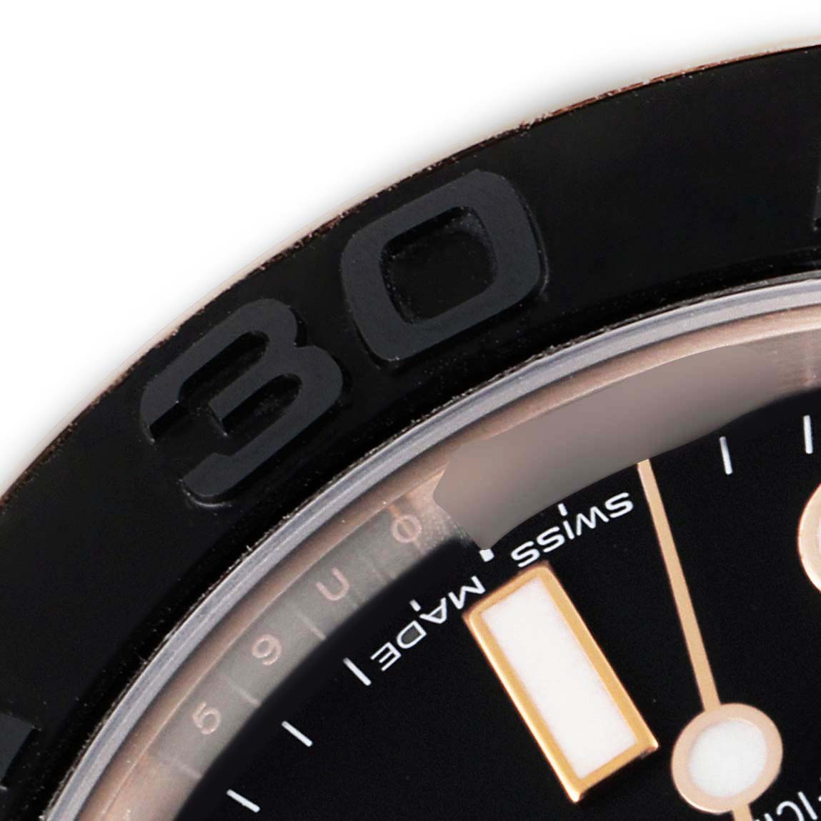 The image shows a close-up of the upper left part of the bezel and dial of a Rolex Yacht-Master 268655 Men's Rose Gold Black Dial 268655 Men's Rose Gold Black Dial watch.