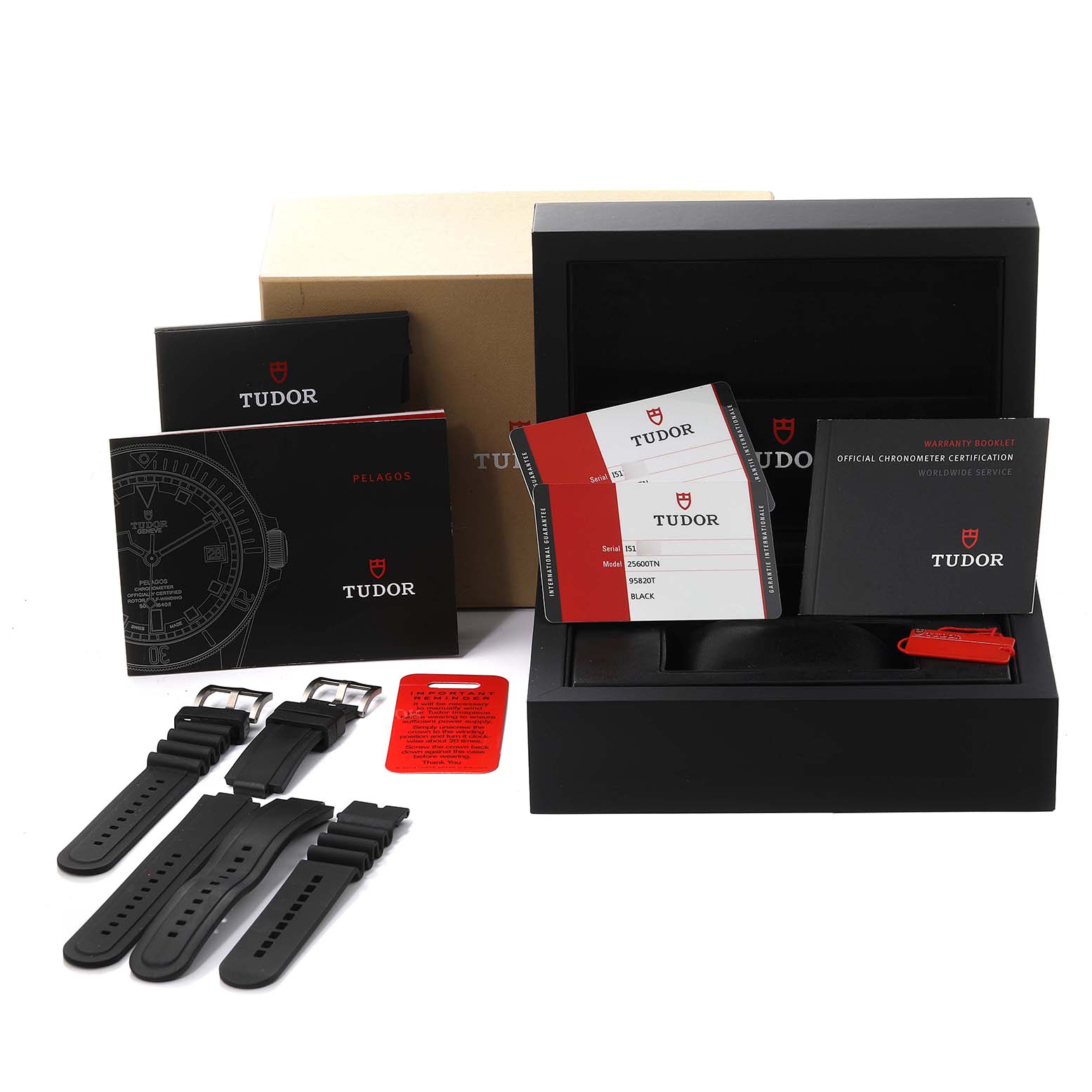 The image shows the Tudor Pelagos 25600TN Men's Titanium Black Dial 25600TN Men's Titanium Black Dial watch box, instruction manuals, warranty booklet, extra straps, and certification cards.