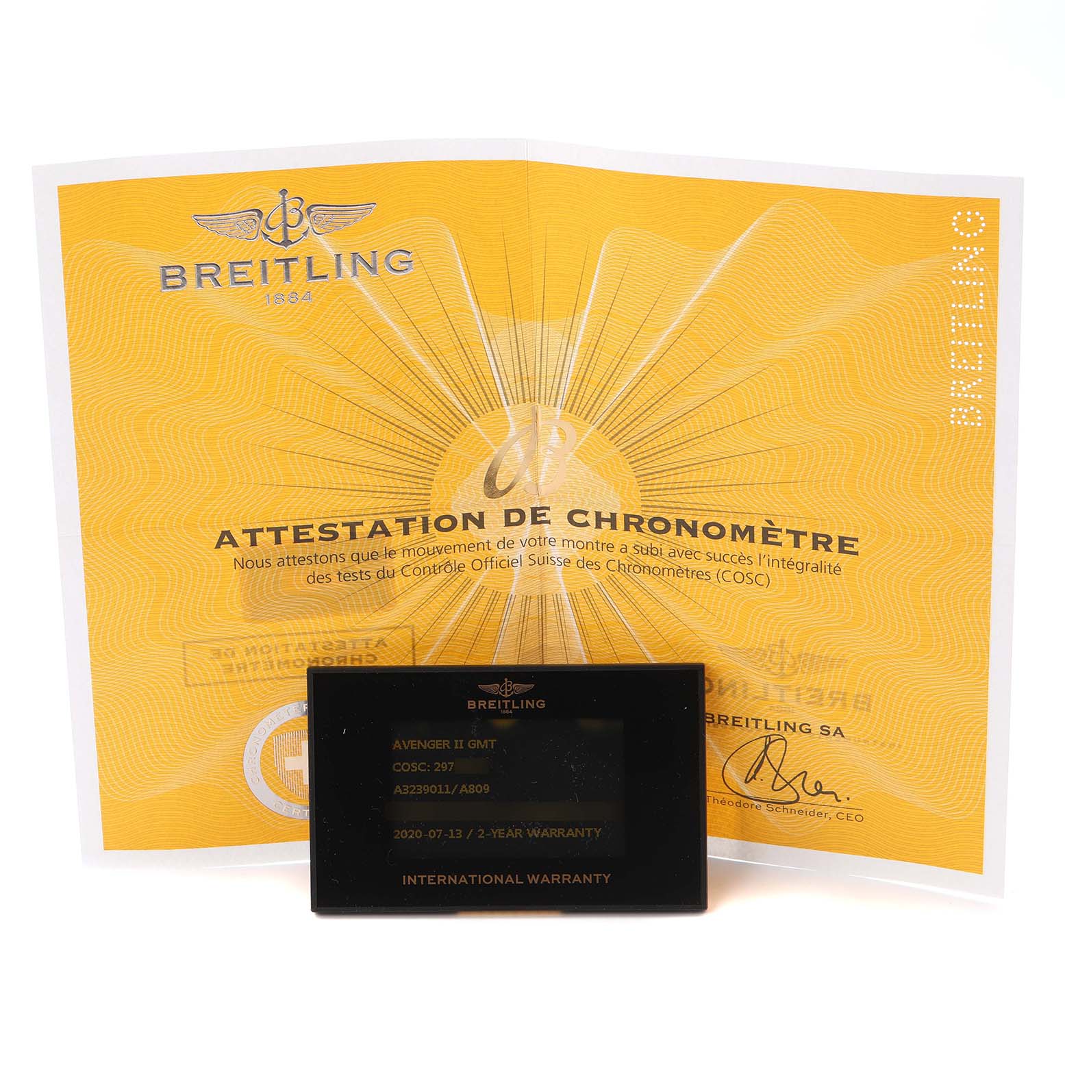 The image shows a Breitling Avenger A32390 Men
s Stainless Steel Mother of Pearl Dial model
s warranty card and chronometer certificate displayed frontally.