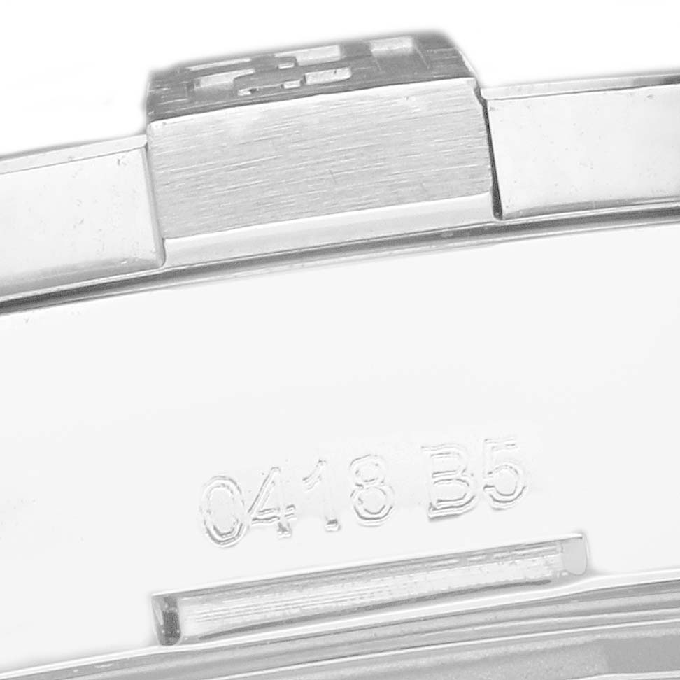 The image shows a close-up of the metal clasp of a Breitling Avenger A32390 Men
s Stainless Steel Mother of Pearl Dial watch, with part numbers visible.