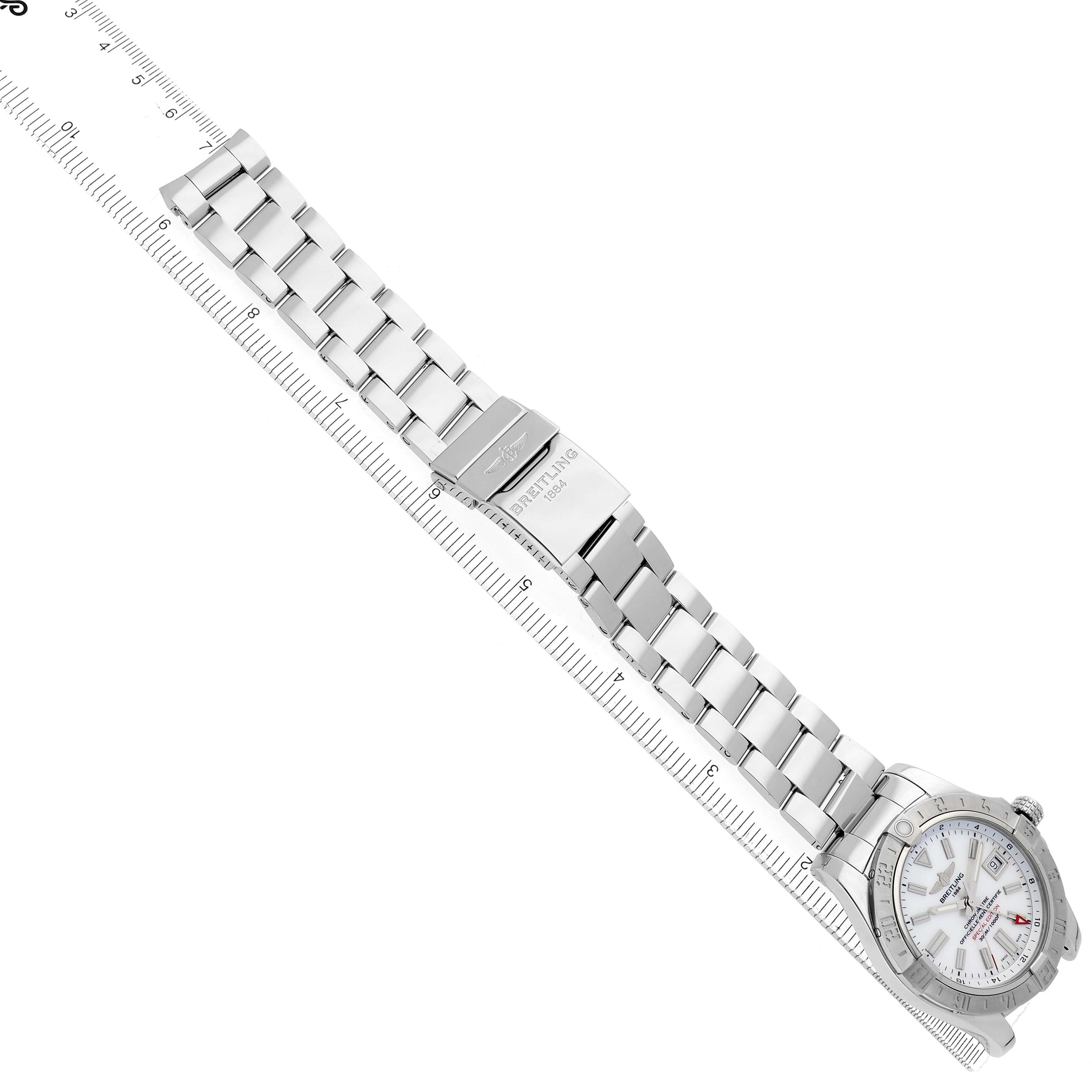 The Breitling Avenger A32390 Men
s Stainless Steel Mother of Pearl Dial watch is shown at an angle, displaying the face, bracelet, and clasp with a ruler for scale.