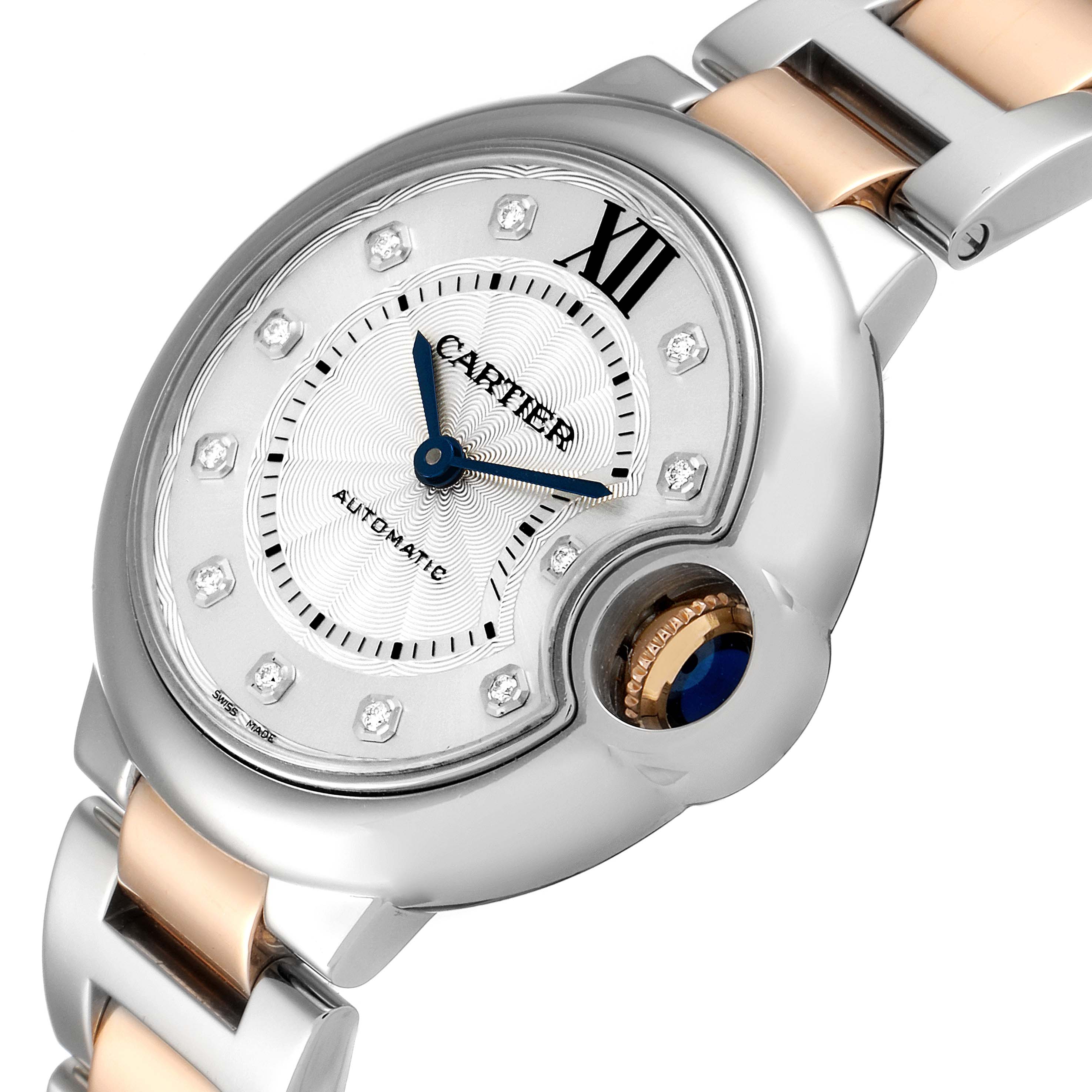 The Cartier Ballon Bleu WE902061 Women's Steel and Gold (two tone) Silver Dial WE902061 Women's Steel and Gold (two tone) Silver Dial watch is shown from an angled close-up, highlighting the dial, blue hands, and part of the bracelet.