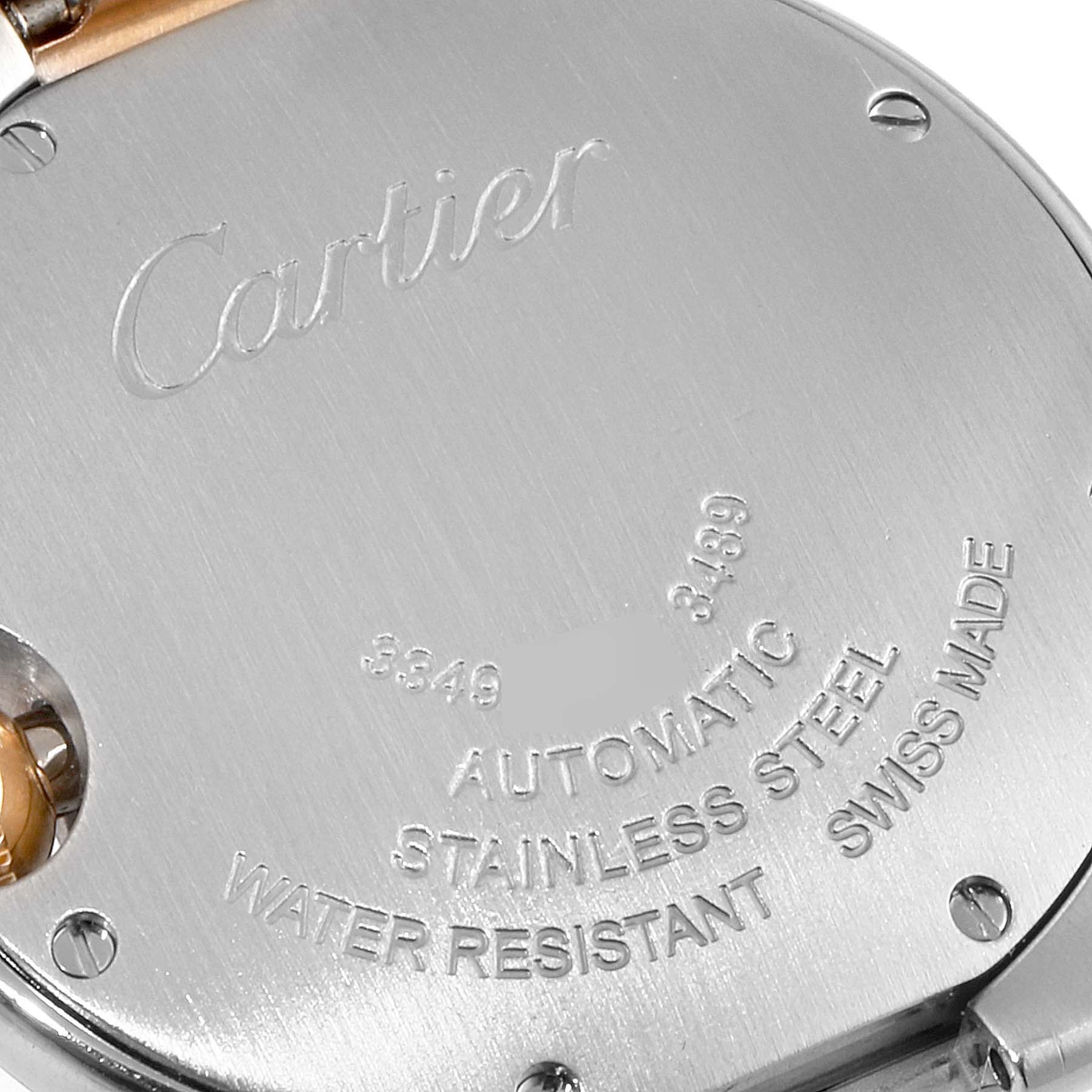 The image shows the back of a Cartier Ballon Bleu WE902061 Women's Steel and Gold (two tone) Silver Dial WE902061 Women's Steel and Gold (two tone) Silver Dial watch, highlighting the engravings and some screws.