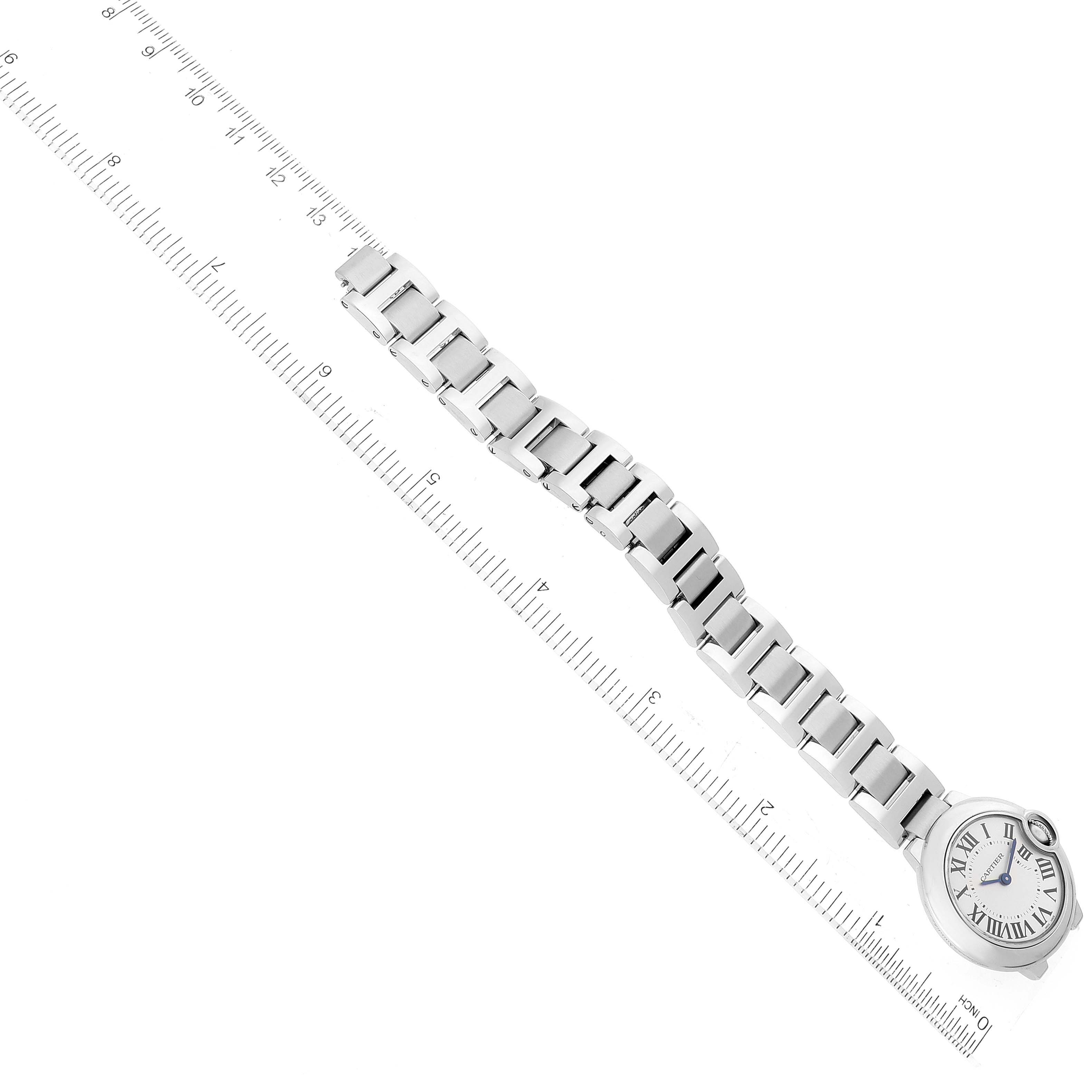 The image shows the Ballon Bleu de Cartier watch laid flat with a metal bracelet, next to a ruler for measurement.
