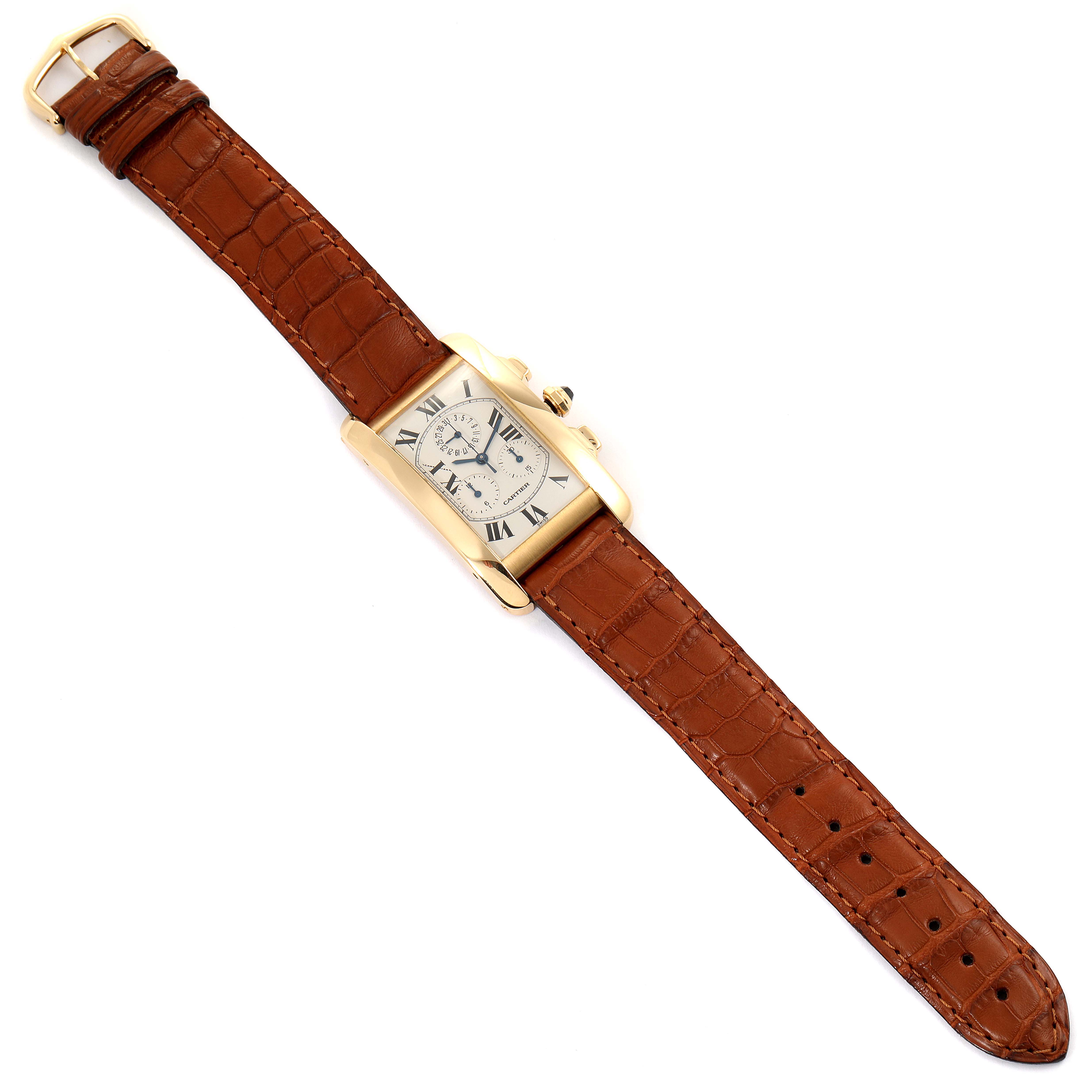 The image shows a Cartier Tank Americaine W2601156 Men's Yellow Gold Silver Dial W2601156 Men's Yellow Gold Silver Dial watch from a top-down angle, featuring its brown leather strap and rectangular face.