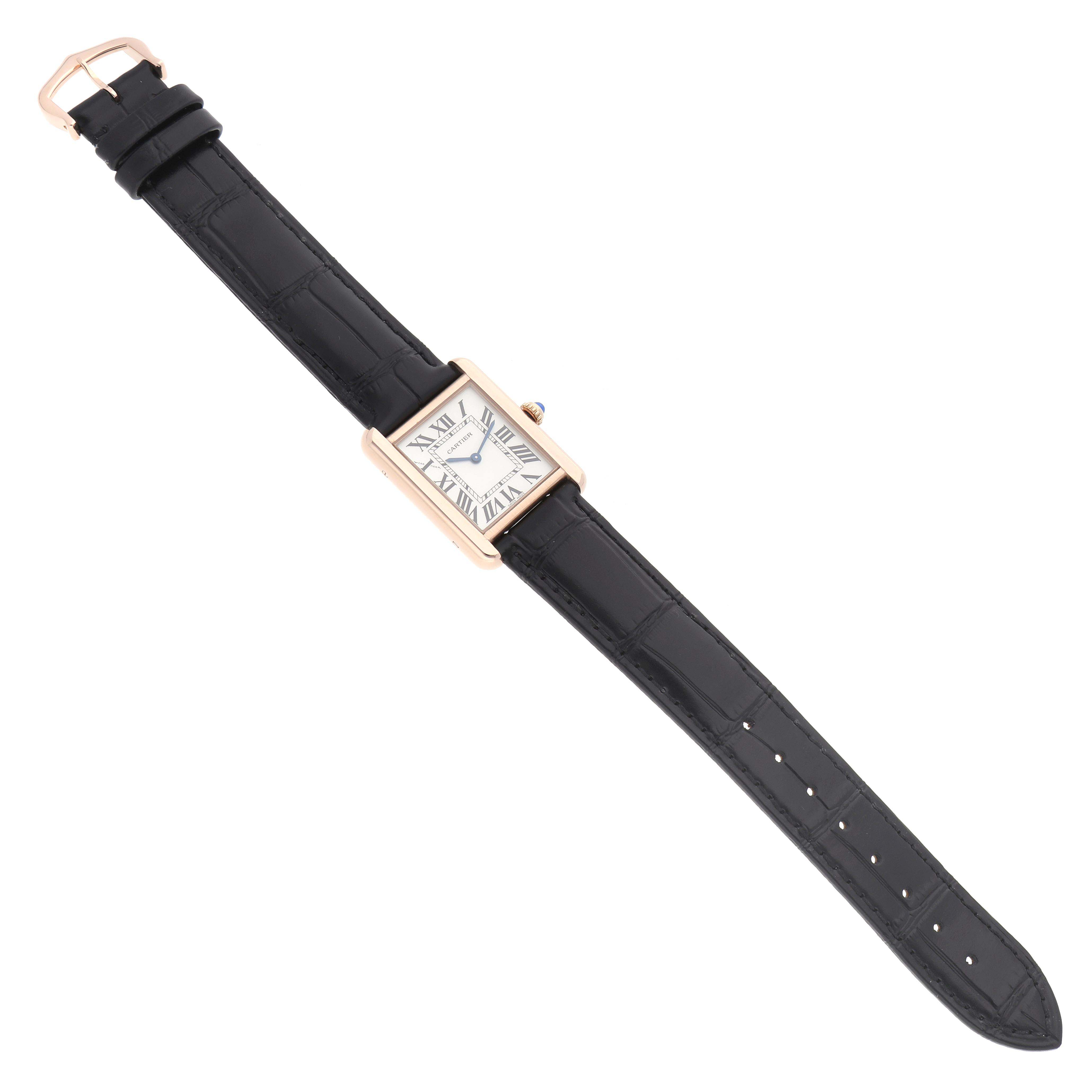 The Cartier Tank Solo W5200002 Women
s Steel and Gold (two tone) Silver Dial watch is shown from a top-down angle, displaying its rectangular face, black strap, and buckle.