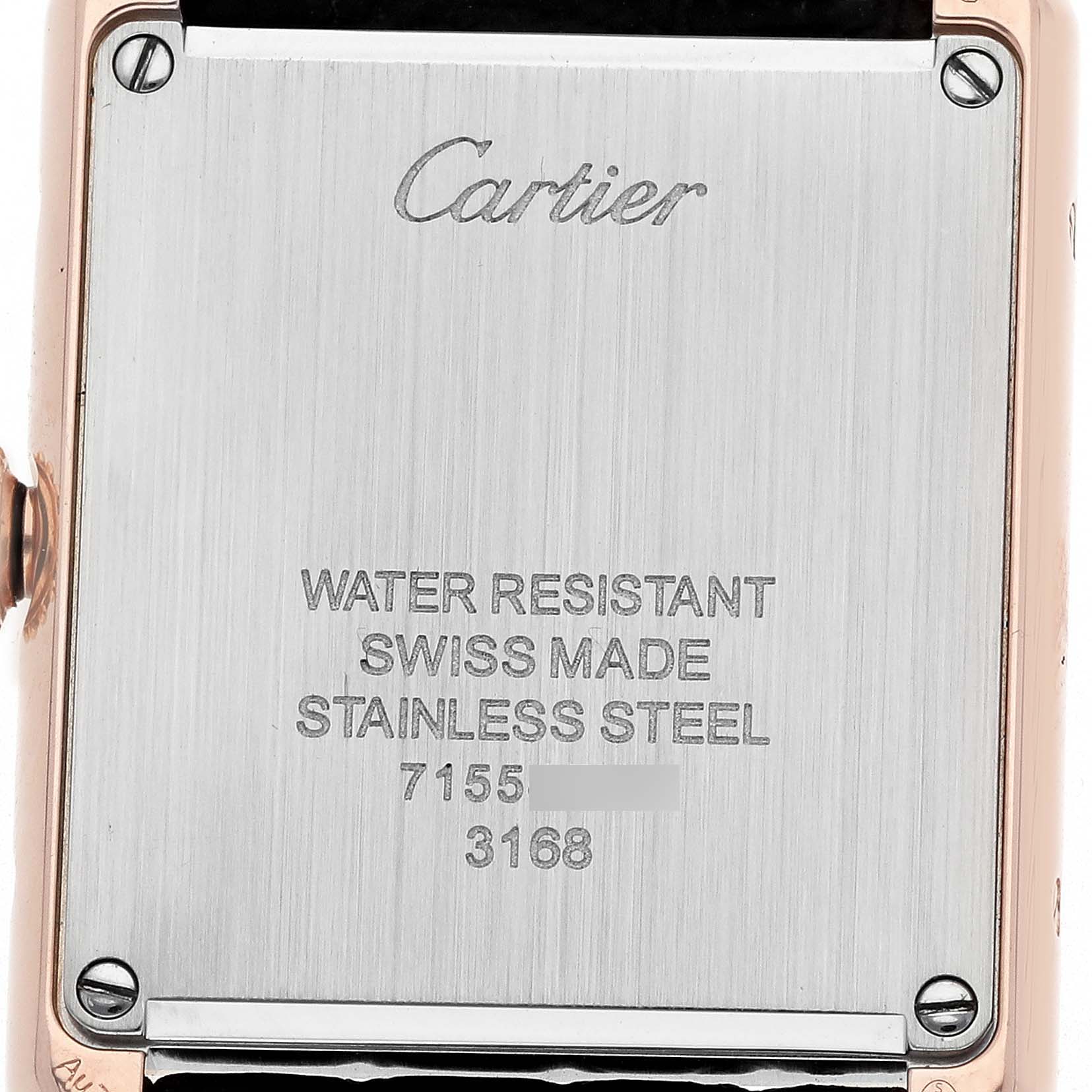 The image shows the back case of a Cartier Tank Solo W5200024 Women
s Rose Gold Silver Dial watch, displaying engravings and screws from a straight angle.