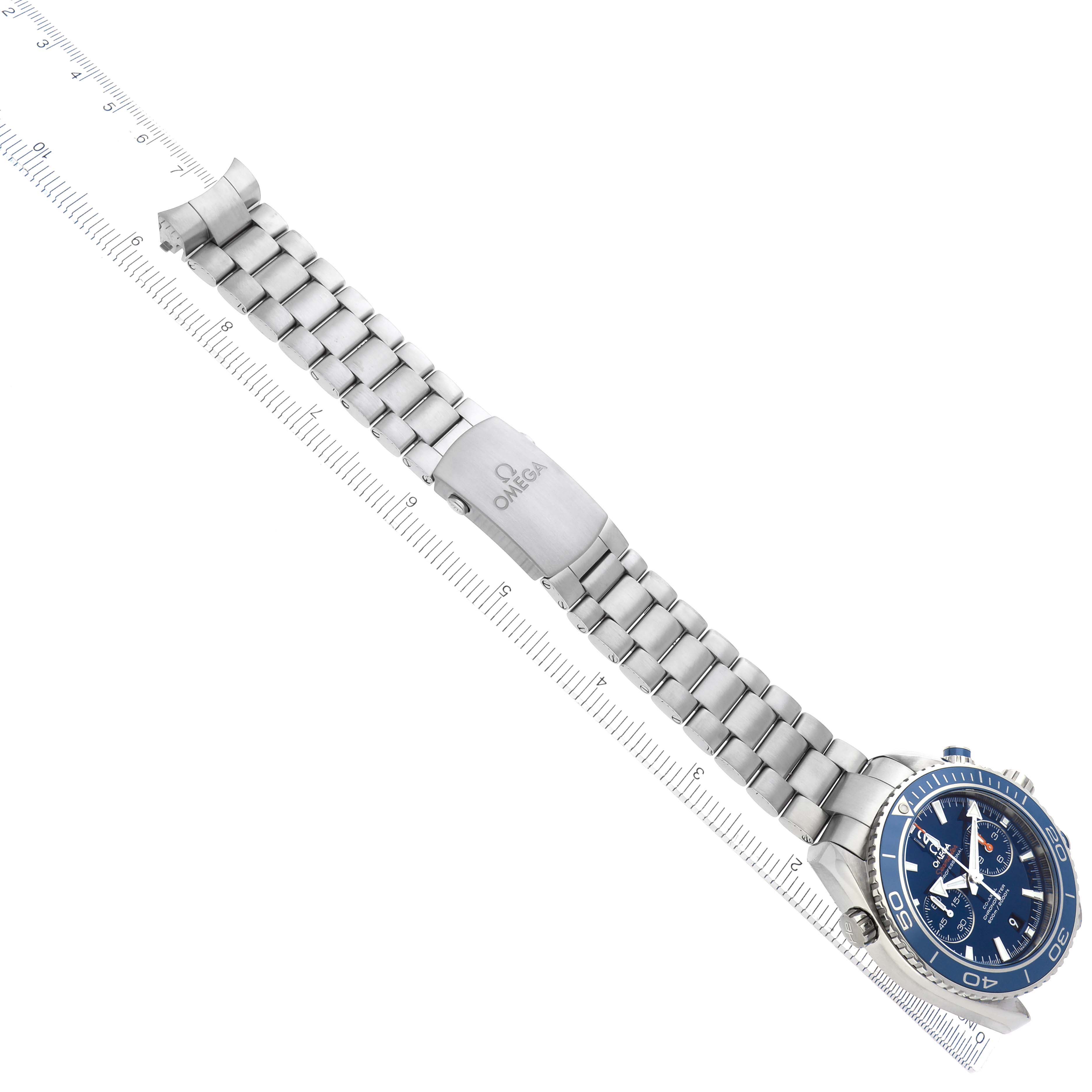 The image shows an Omega Planet Ocean 232.90.46.51.03.001 Men
s Titanium Blue Dial watch at an angled view, highlighting the face, bezel, and metal bracelet with clasp.