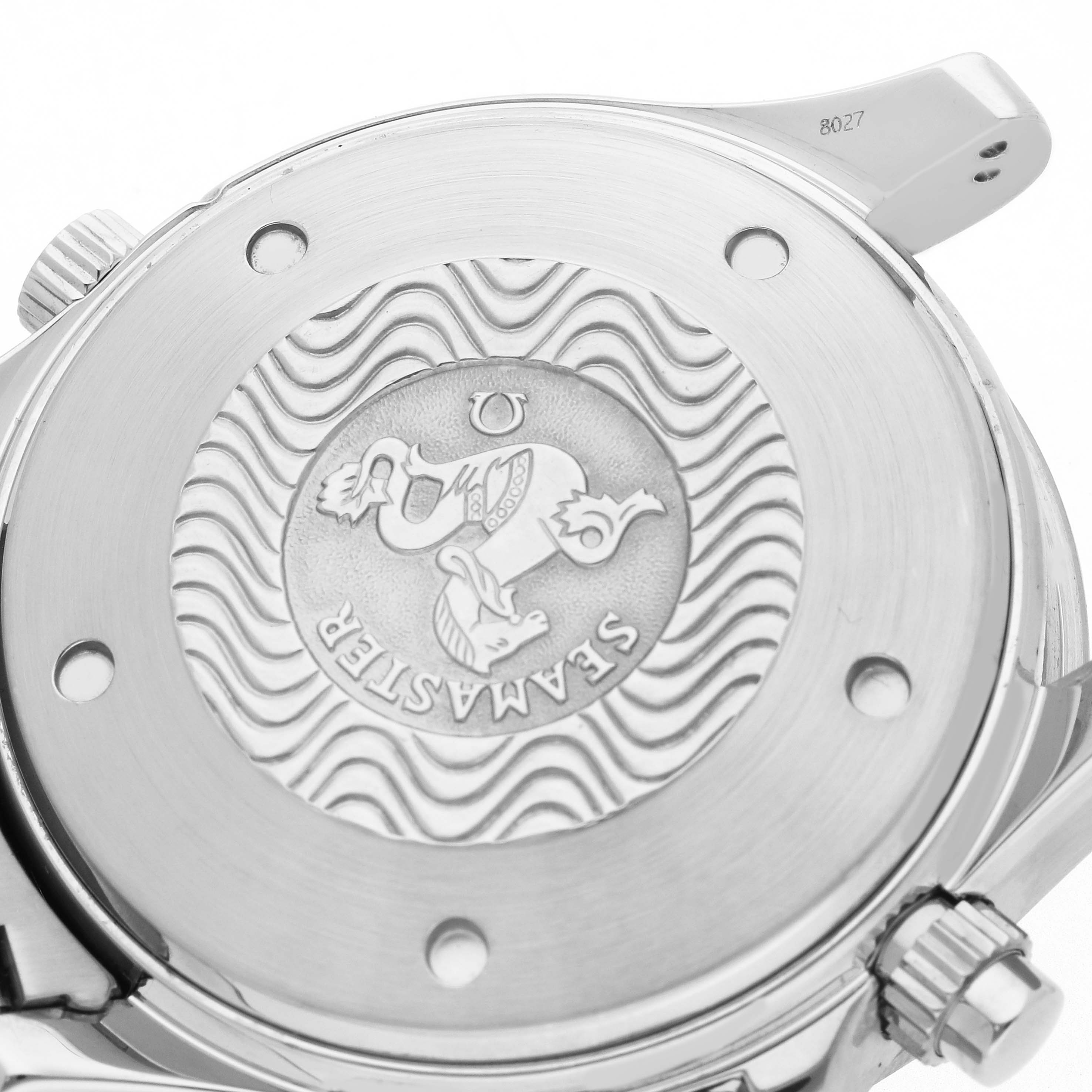 The image shows the back case of an Omega Seamaster 2598.20.00 Men
s Stainless Steel White Dial watch, including the engraved emblem and wavy pattern, viewed from a rear angle.