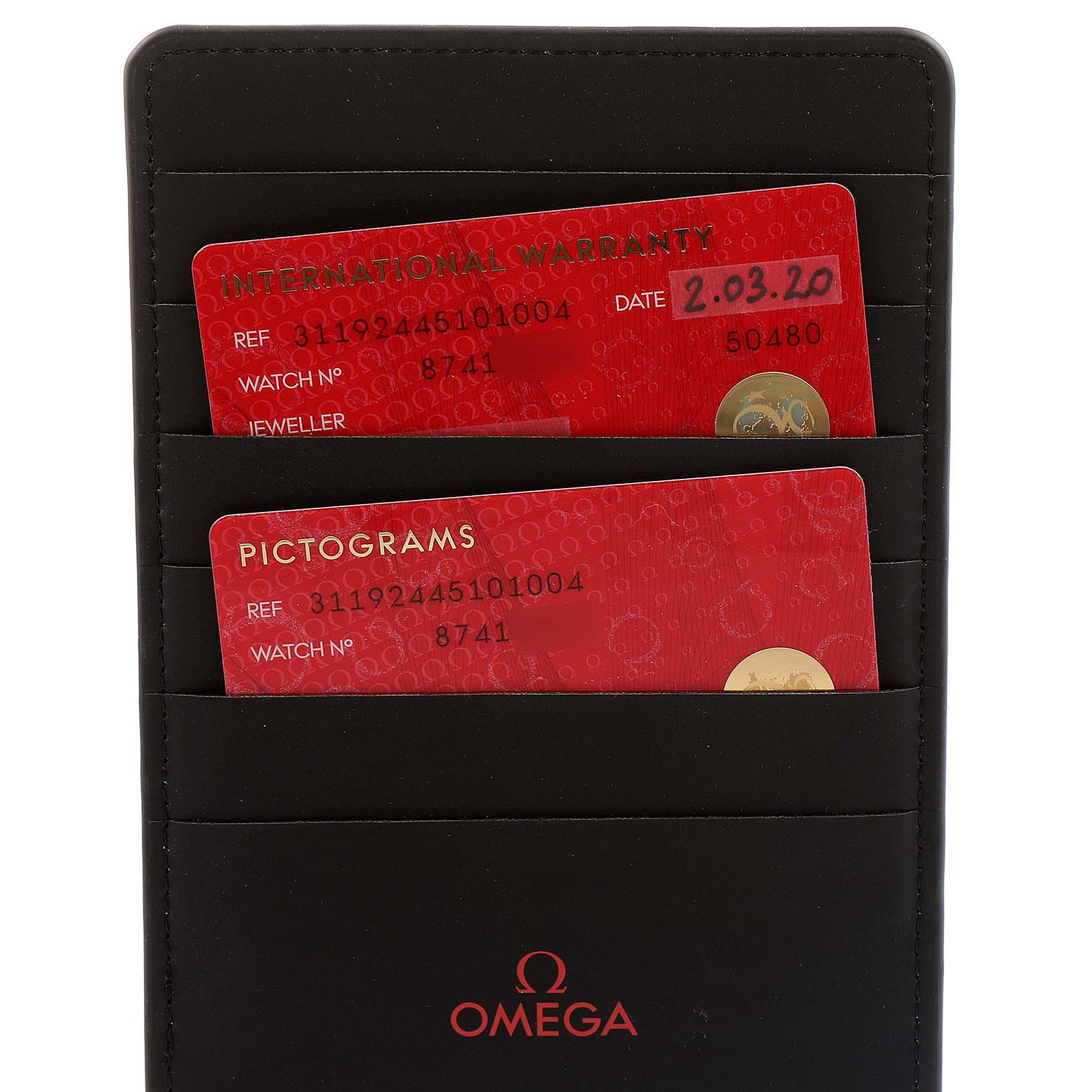 The image shows two red cards, "International Warranty" and "Pictograms," in a black Omega wallet related to an Omega Speedmaster 311.92.44.51.01.004 Men's Ceramic Black Dial 311.92.44.51.01.004 Men's Ceramic Black Dial watch.
