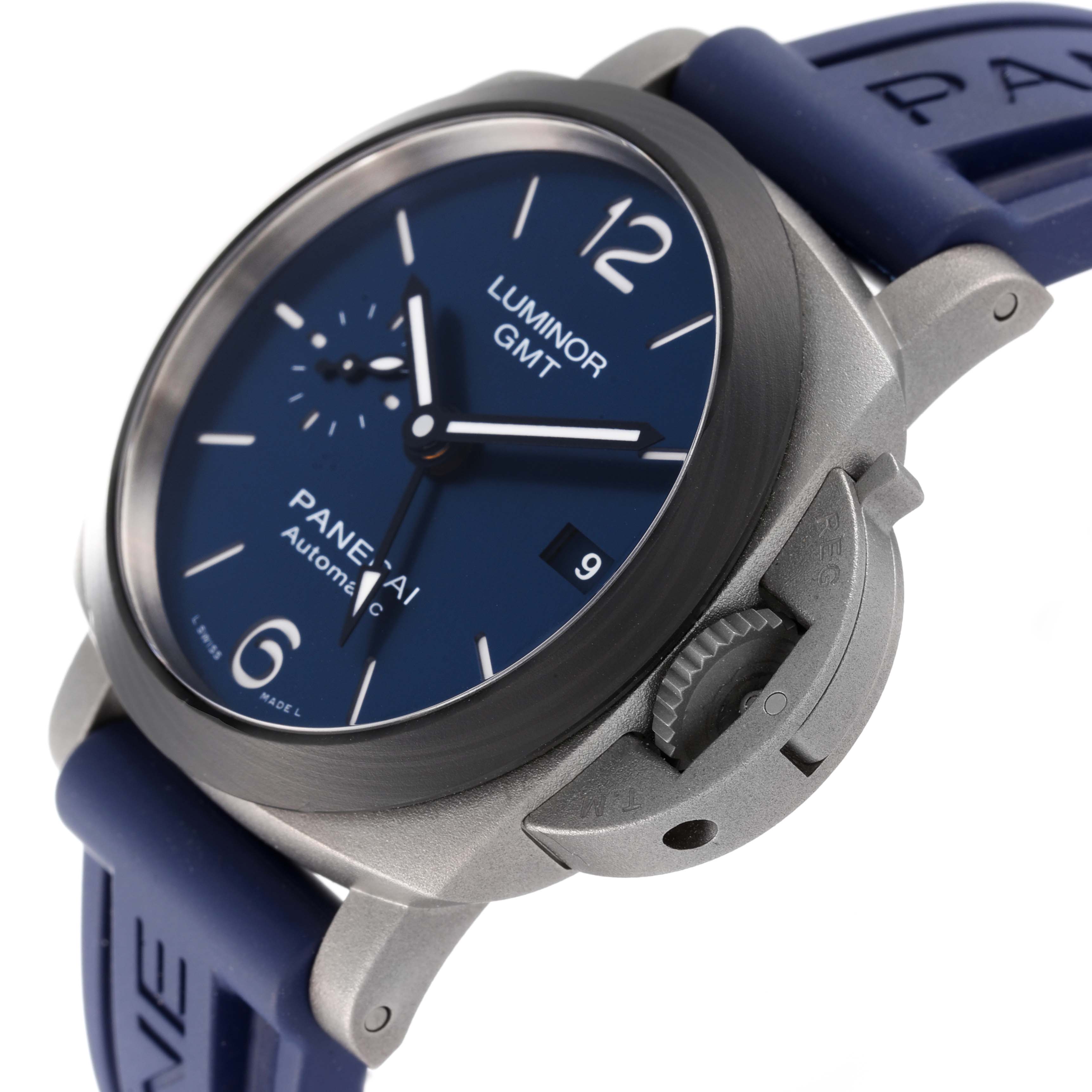 The image shows a close-up angle of the Panerai Luminor PAM01279 Men's Titanium Blue Dial PAM01279 Men's Titanium Blue Dial GMT watch, focusing on its blue dial, crown, and blue strap.