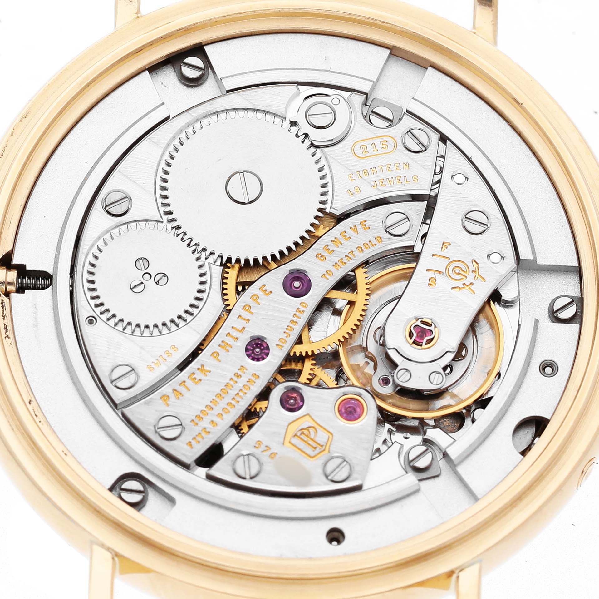 This image shows the Calatrava model by Patek Philippe from the back, highlighting the intricate mechanics and gears.