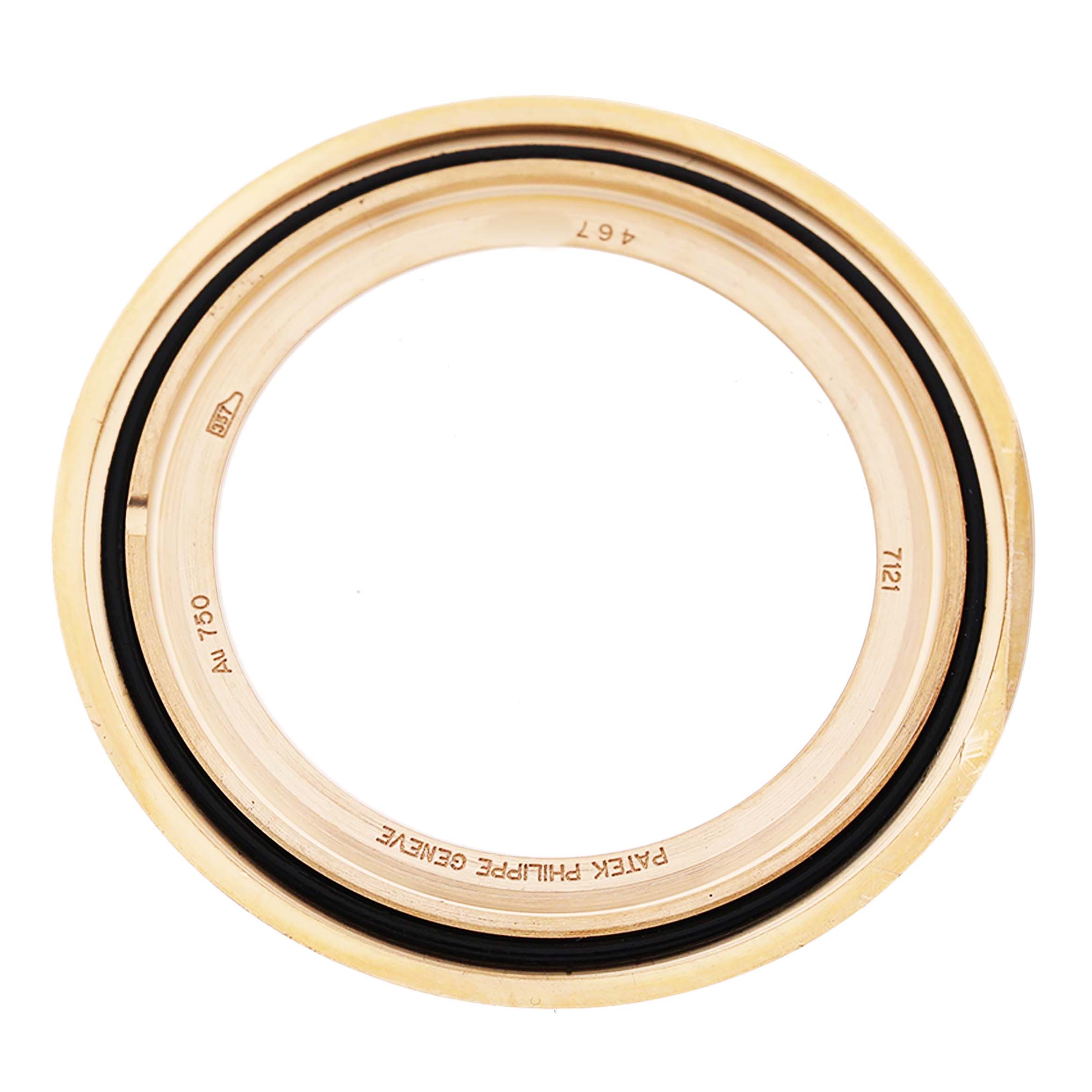The image shows a gold watch bezel for a Patek Philippe Calatrava 7121J-001 Women's Yellow Gold Silver Dial, viewed from the top, displaying internal engravings.