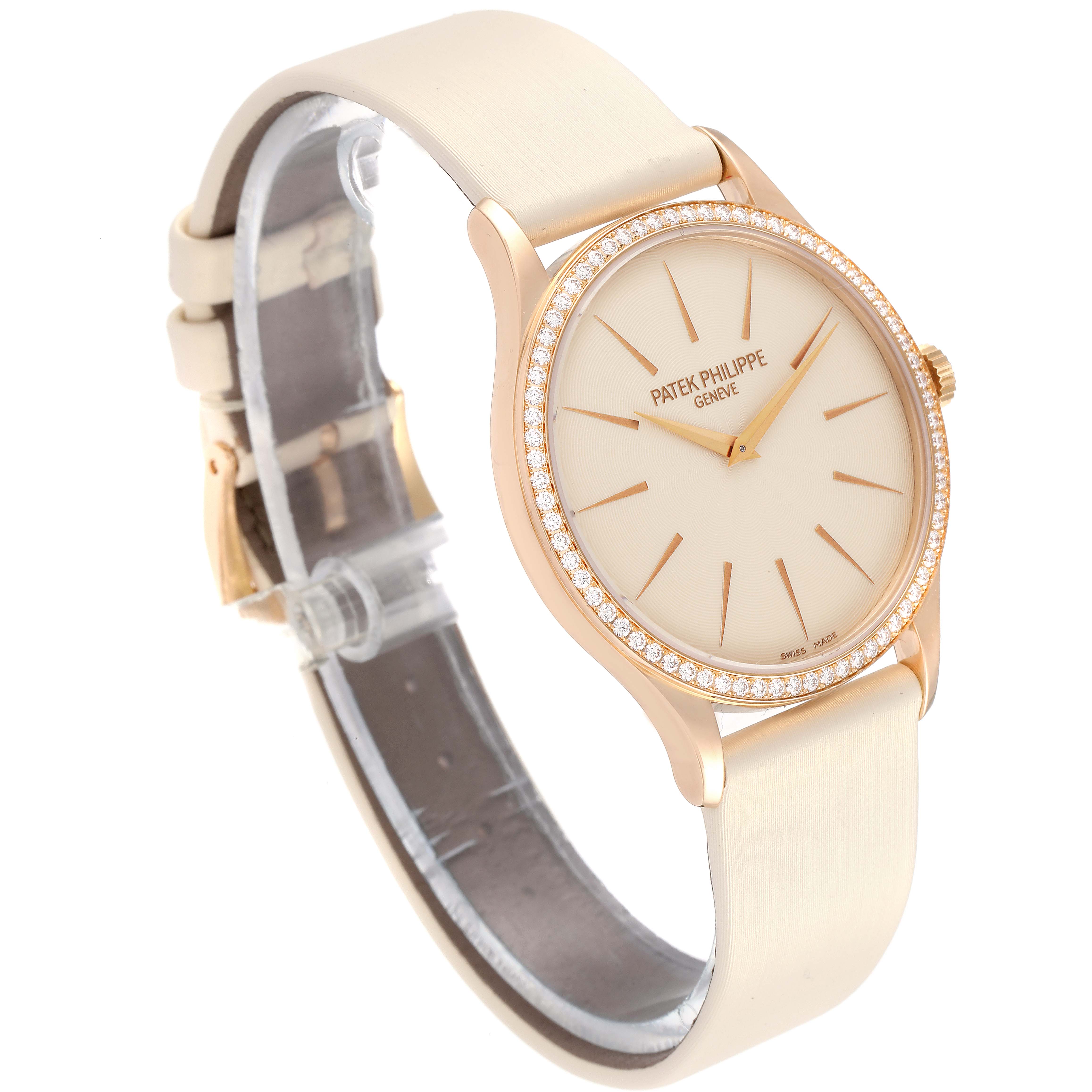 The image shows a Patek Philippe Calatrava 4897R-010 Women
s Rose Gold Beige Dial 4897R-010 Women
s Rose Gold Beige Dial watch at a slight side angle, highlighting its face, bezel, and partially open strap.