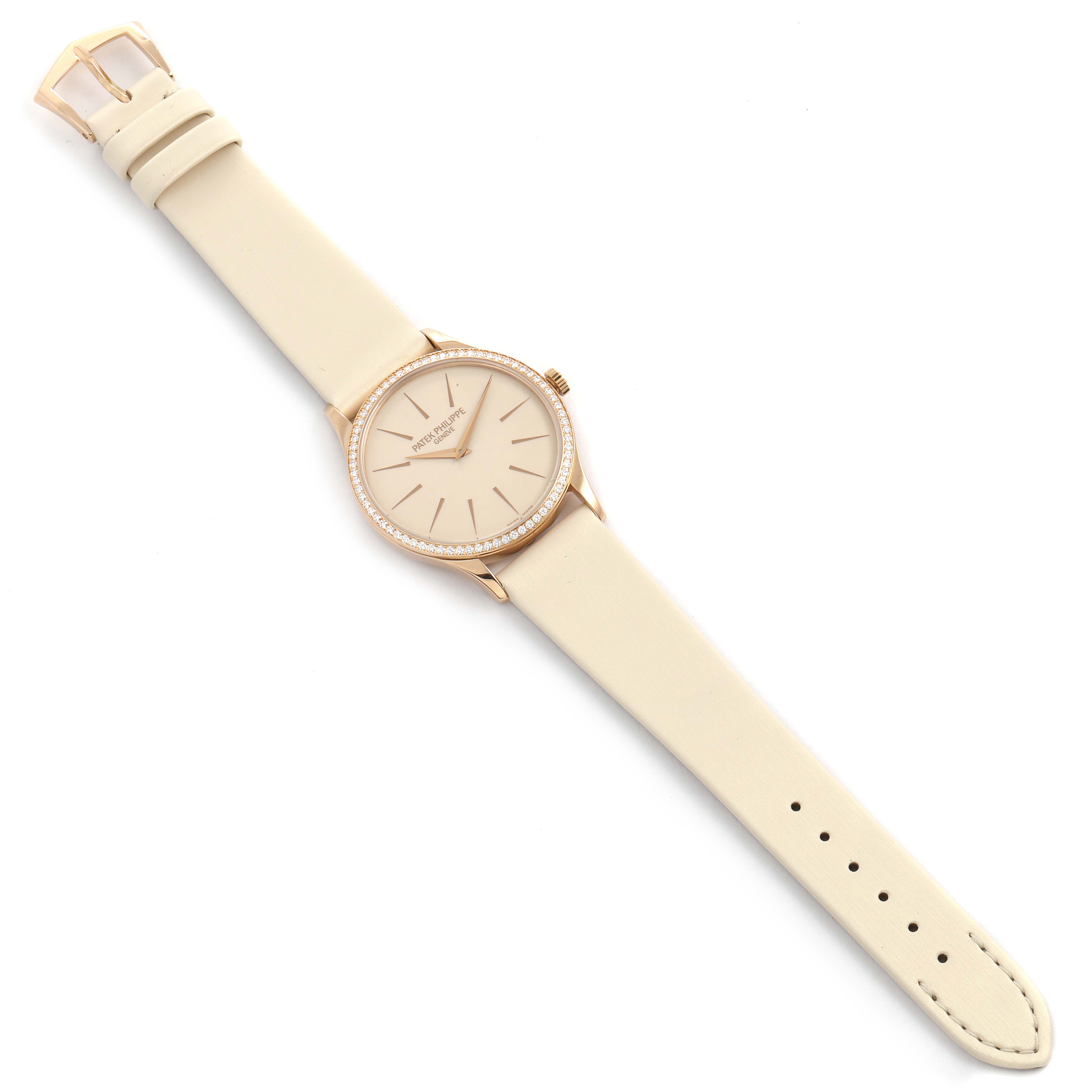 This image shows a top-down view of a Patek Philippe Calatrava 4897R-010 Women
s Rose Gold Beige Dial 4897R-010 Women
s Rose Gold Beige Dial watch, highlighting its beige strap and round face with diamond accents.