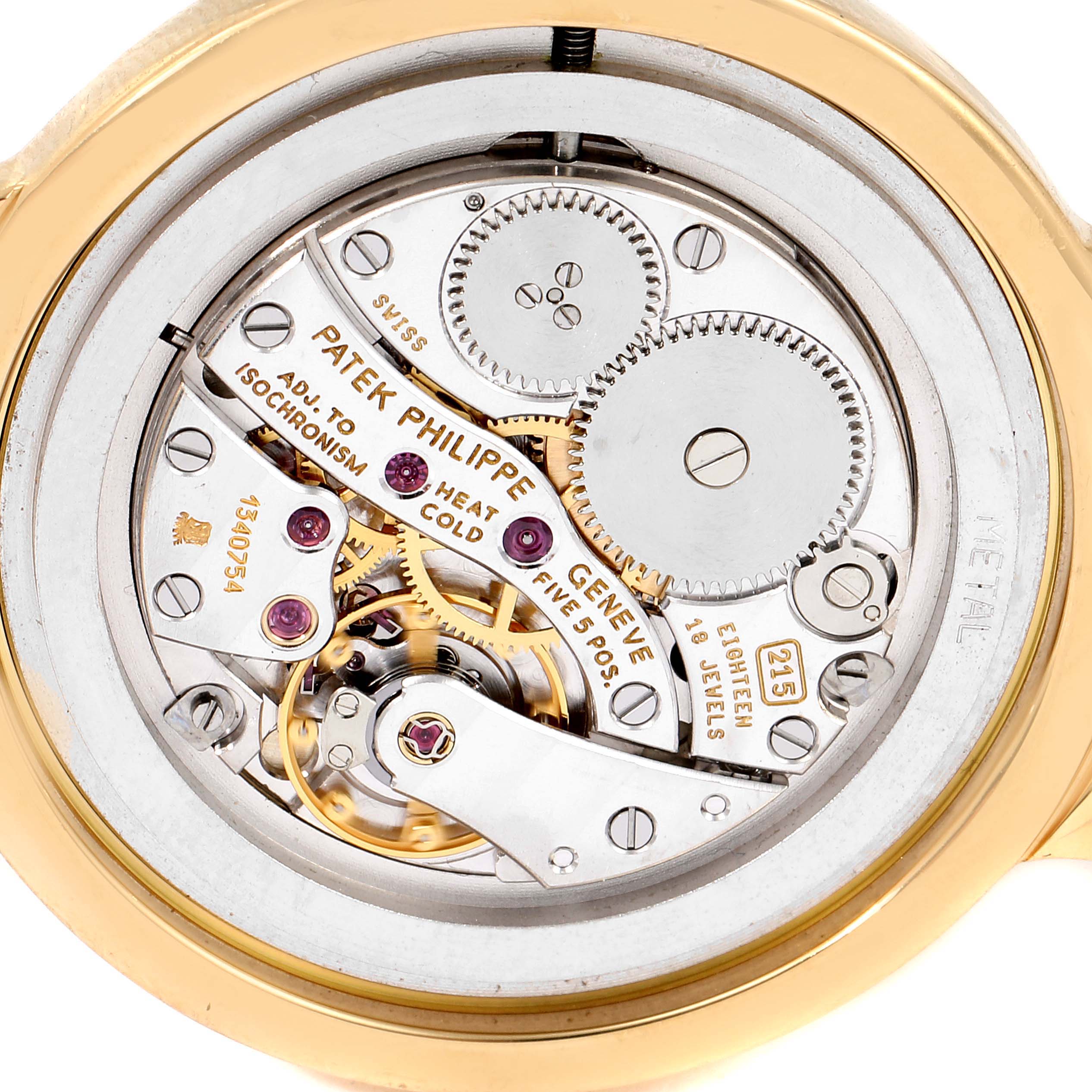 The image shows a close-up view of the movement inside a Patek Philippe Calatrava 3915J Men's Yellow Gold Silver Dial 3915J Men's Yellow Gold Silver Dial watch, displaying intricate gears and mechanisms.